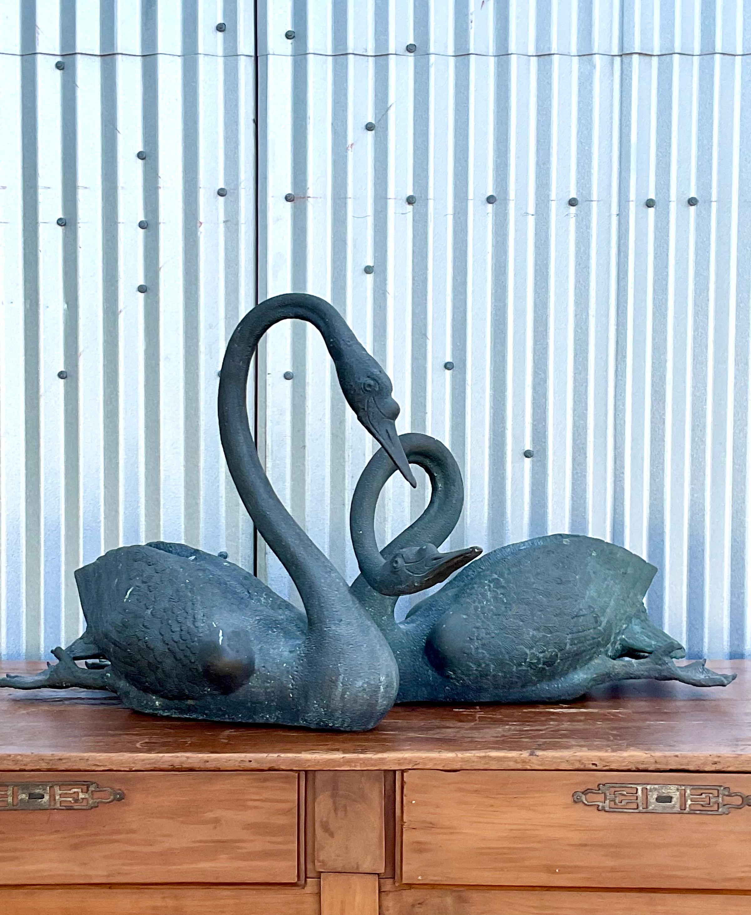 Incredible pair of vintage life size bronze swans. Beautiful sculpted detail and dramatic poses. Acquired from a Palm Beach estate.