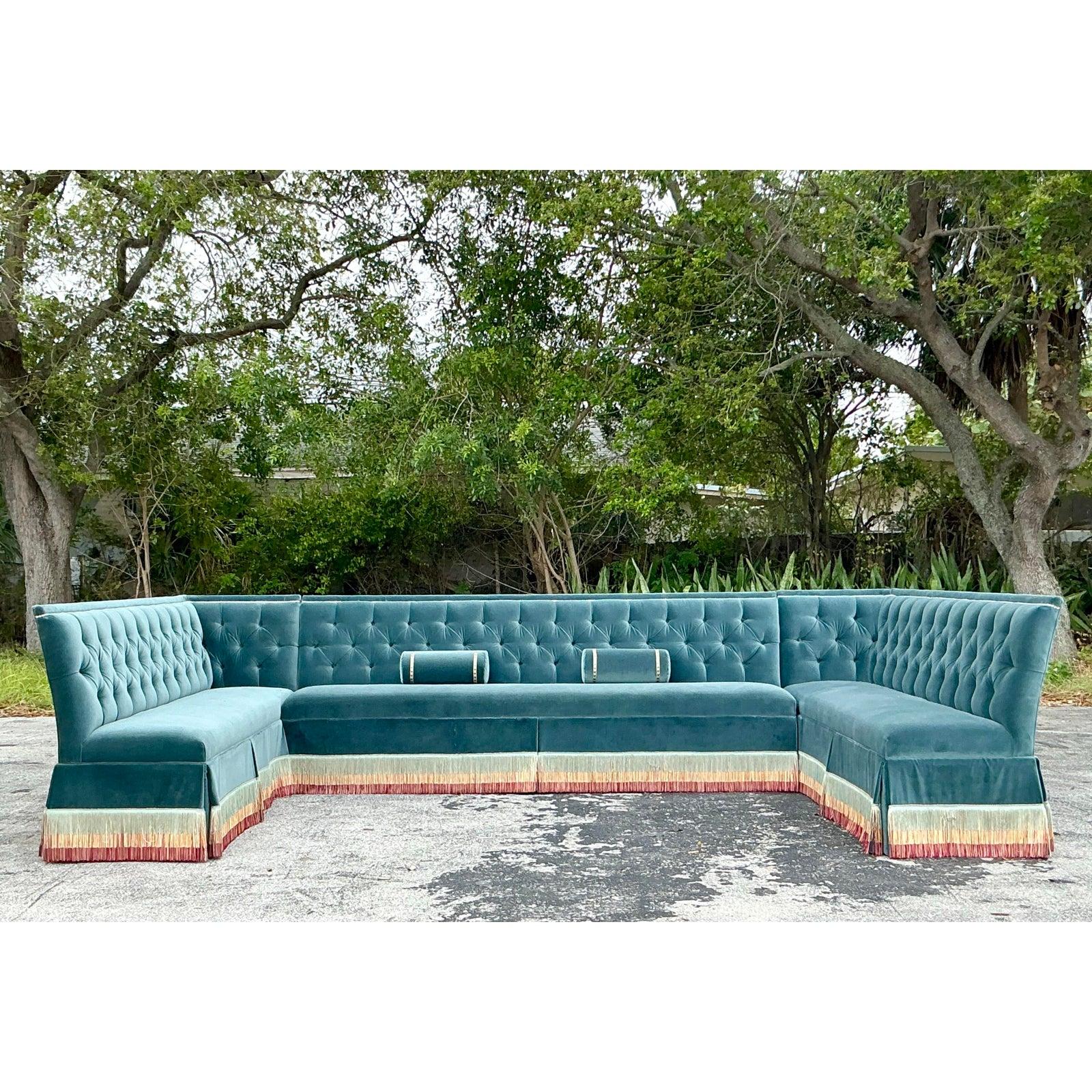 Make a statement with this magnificent vintage Regency-style custom tufted banquette sofa, designed in the style of Bunny Williams. Featuring a grand 156.5-inch width x 92-inch depth x 39.5-inch back height, this monumental piece exudes