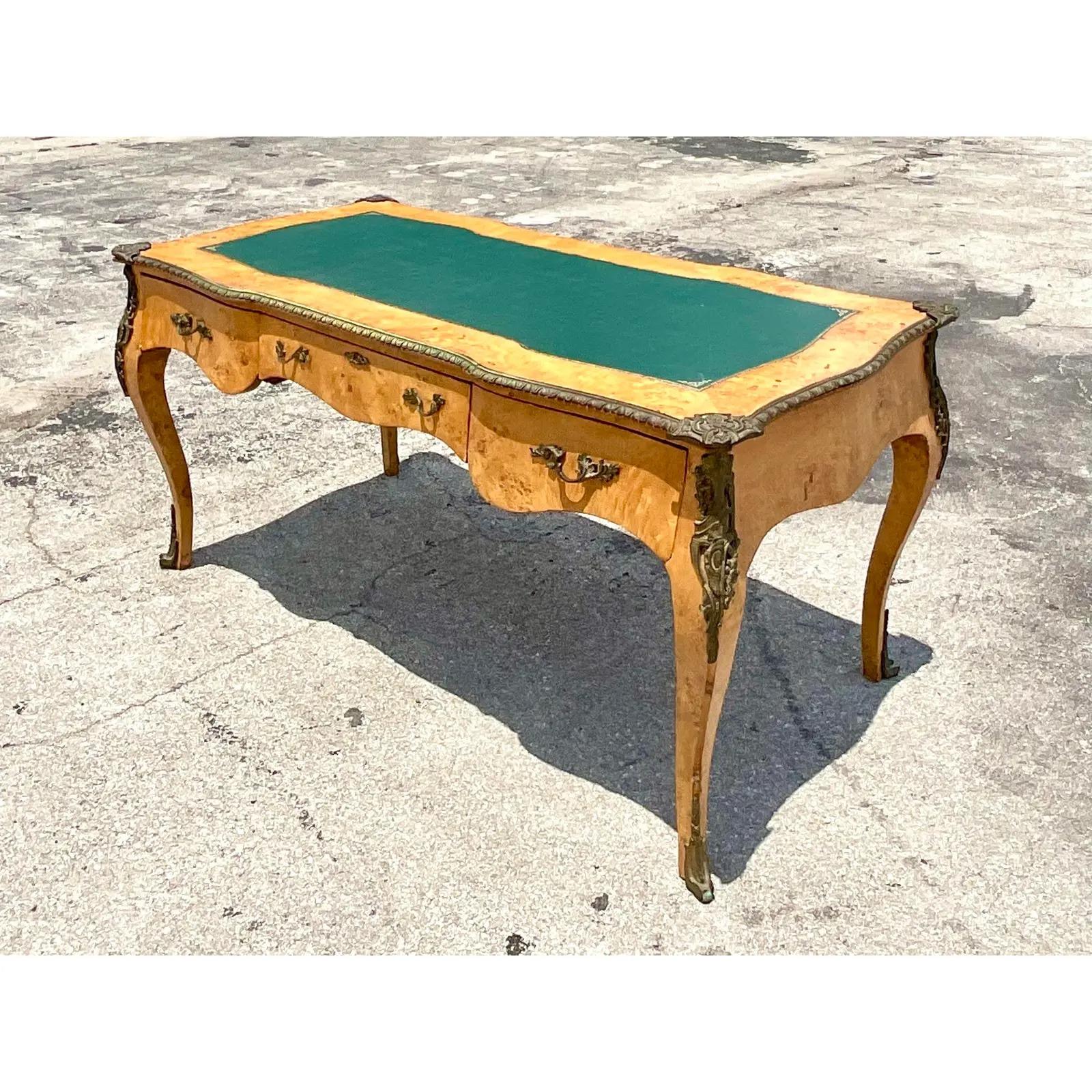 Fabulous vintage Regency writing desk. Beautiful Burl frame with and inset leather top and brass Ormolu details. Large and impressive. Acquired from a Palm Beach estate.