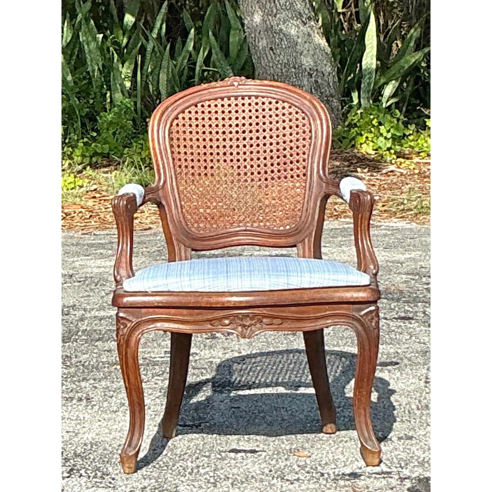Eleganza raffinata per i tuoi interni con questa sedia vintage Regency Cane Fauteuil. Realizzato a mano con una splendida cornice in legno intagliato e uno schienale scolpito a canne, questo pezzo cattura il fascino senza tempo del design Regency di