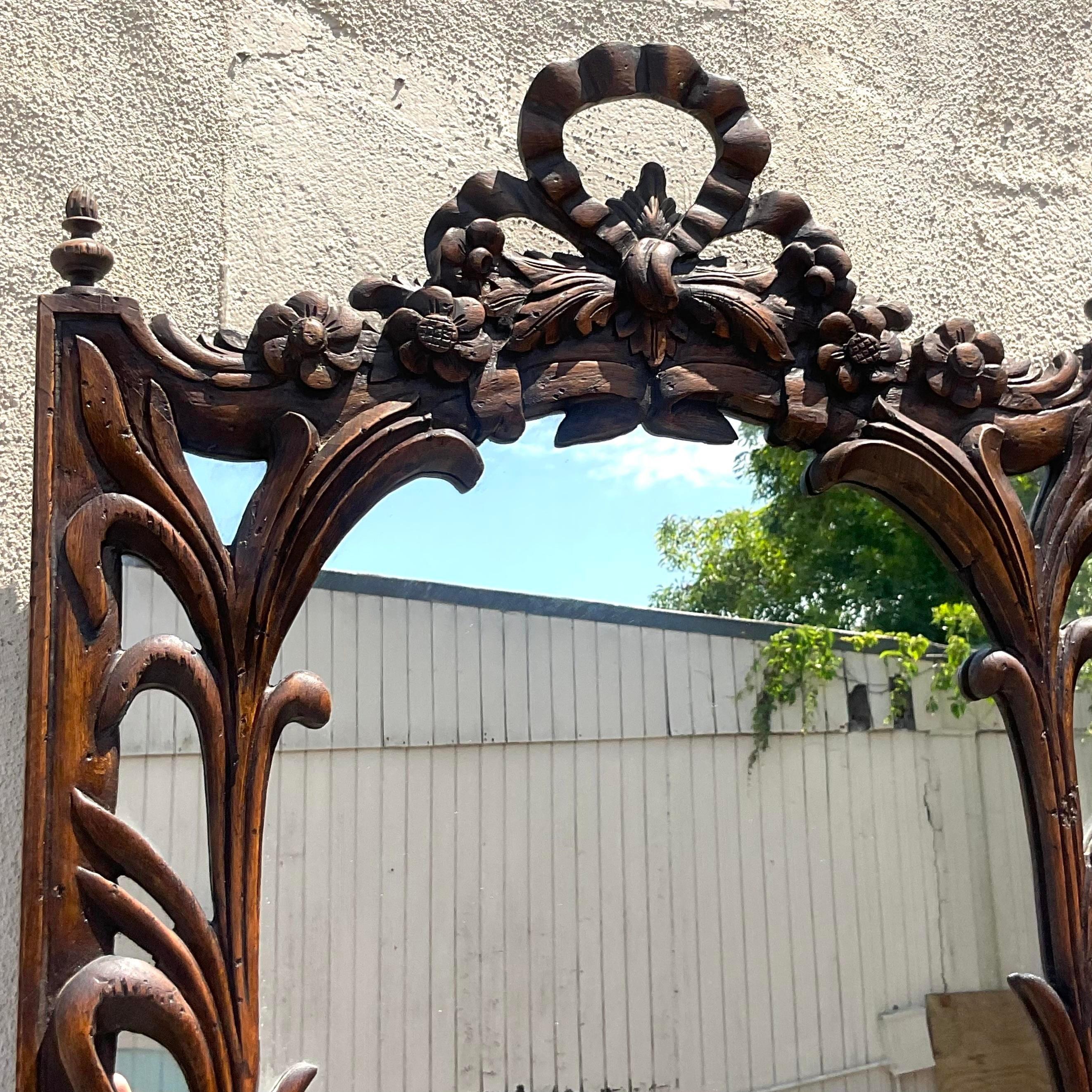 Experience timeless elegance with our Vintage Regency Carved Bow and Lily Mirror. American-crafted with exquisite bow and lily motifs, this mirror captures classic Regency style, blending intricate carving with refined glamour for a luxurious