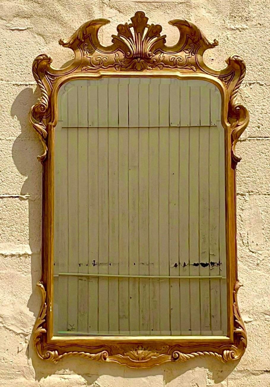 A chic vintage Regency gilt mirror. Beautiful hand carved detail. Acquired from a Palm Beach estate.
