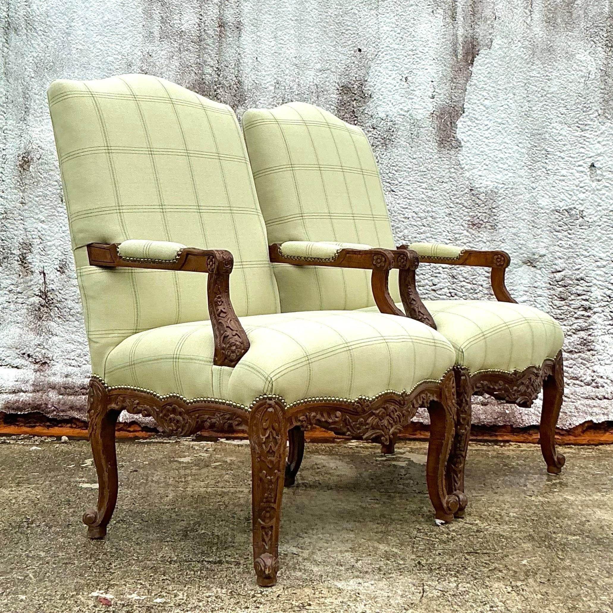 Add a touch of opulence to your space with this exquisite pair of vintage Regency carved high-back chairs. With their elegantly detailed woodwork and stately silhouette, these chairs exude timeless sophistication. The high backs and rich