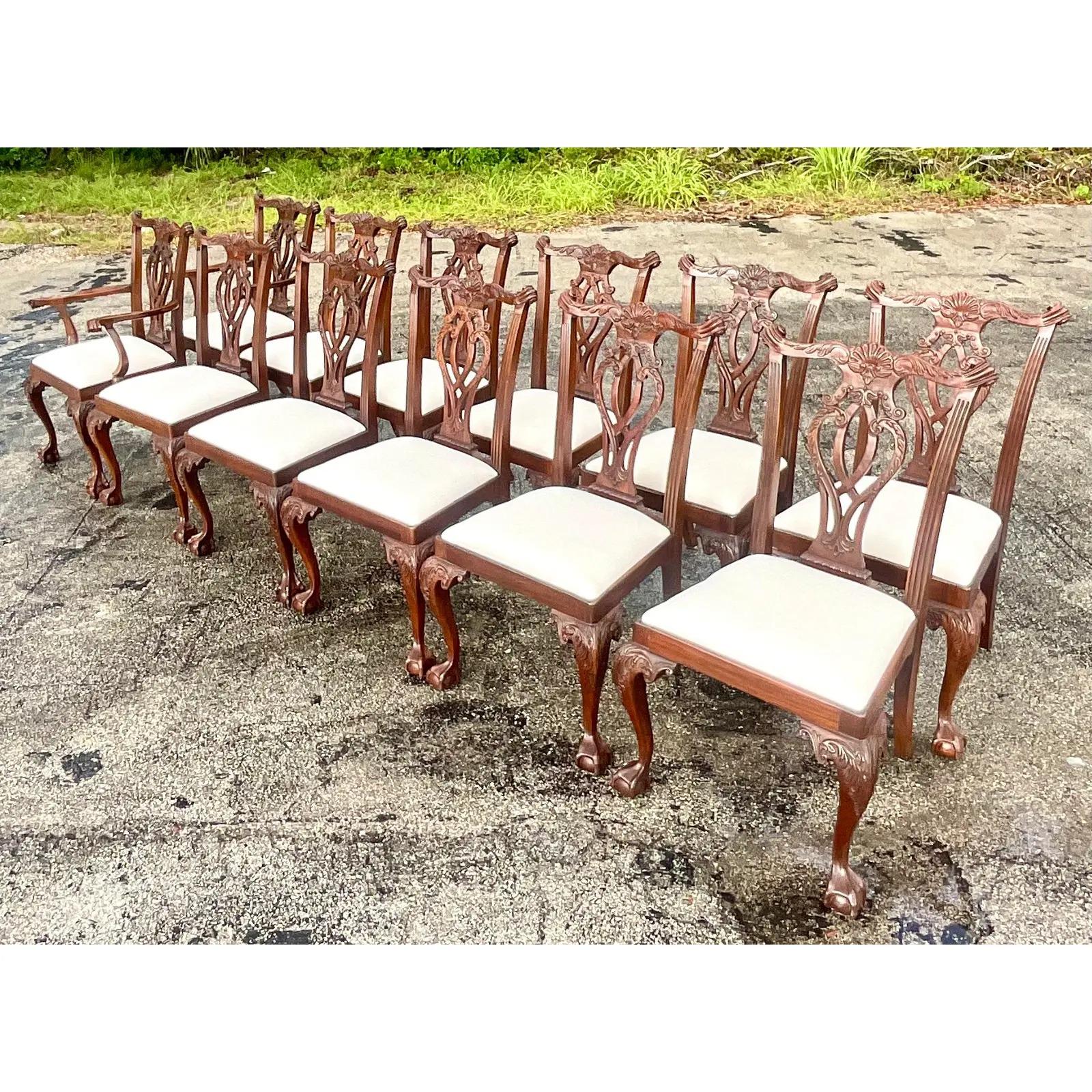 A fantastic set of 12 vintage Regency Mahogany dining chairs. Beautiful hand carved Chippendale design with a bright white seat. Incredible carved detail on the back and the cabriolet legs. Acquired from a Palm Beach estate.

Side chair dimensions