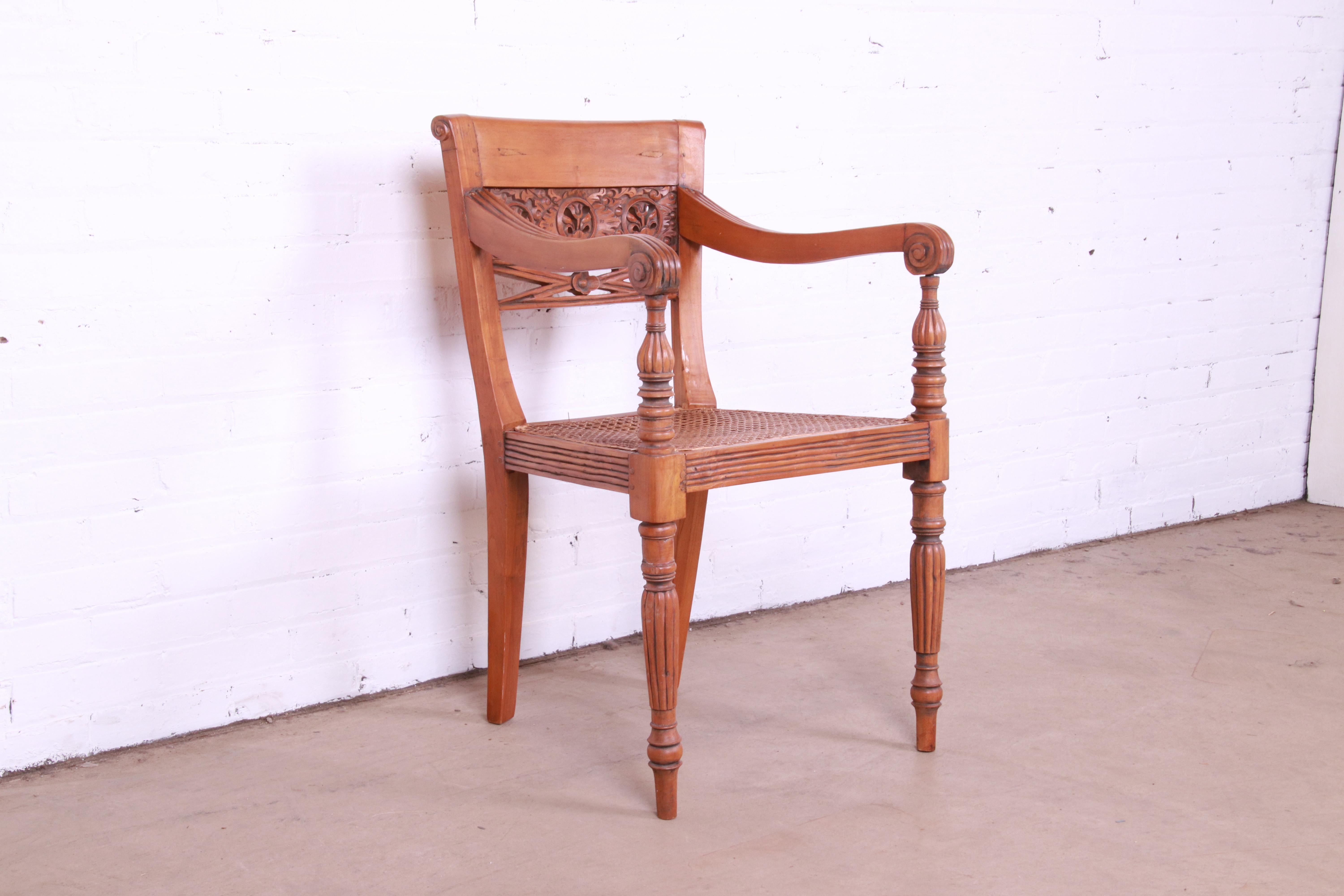 A beautiful Regency style desk chair or side chair

Circa 1940s

Carved walnut, with caned seat.

Measures: 22