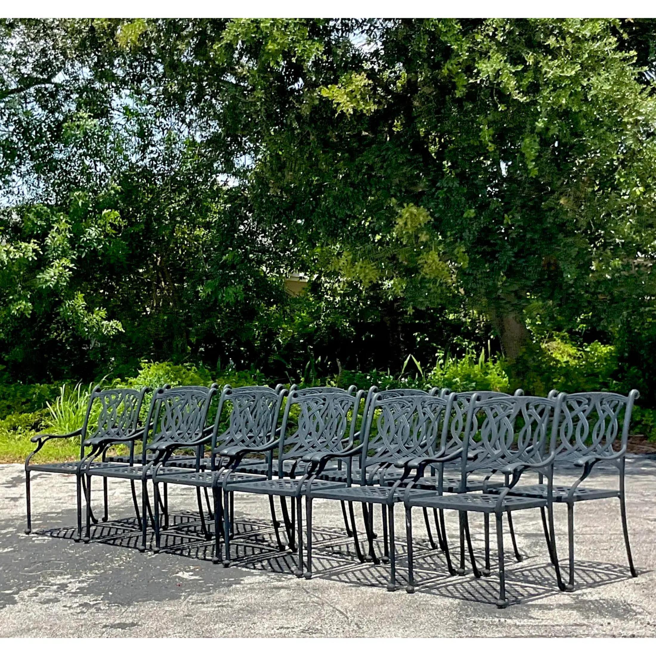 A fabulous set of 12 vintage Coastal outdoor dining chairs. Made in a durable cast aluminum. A much better material if your project is close to any ocean. Lighter weight and easy to move, yet super durable. Currently a matte black, but easily