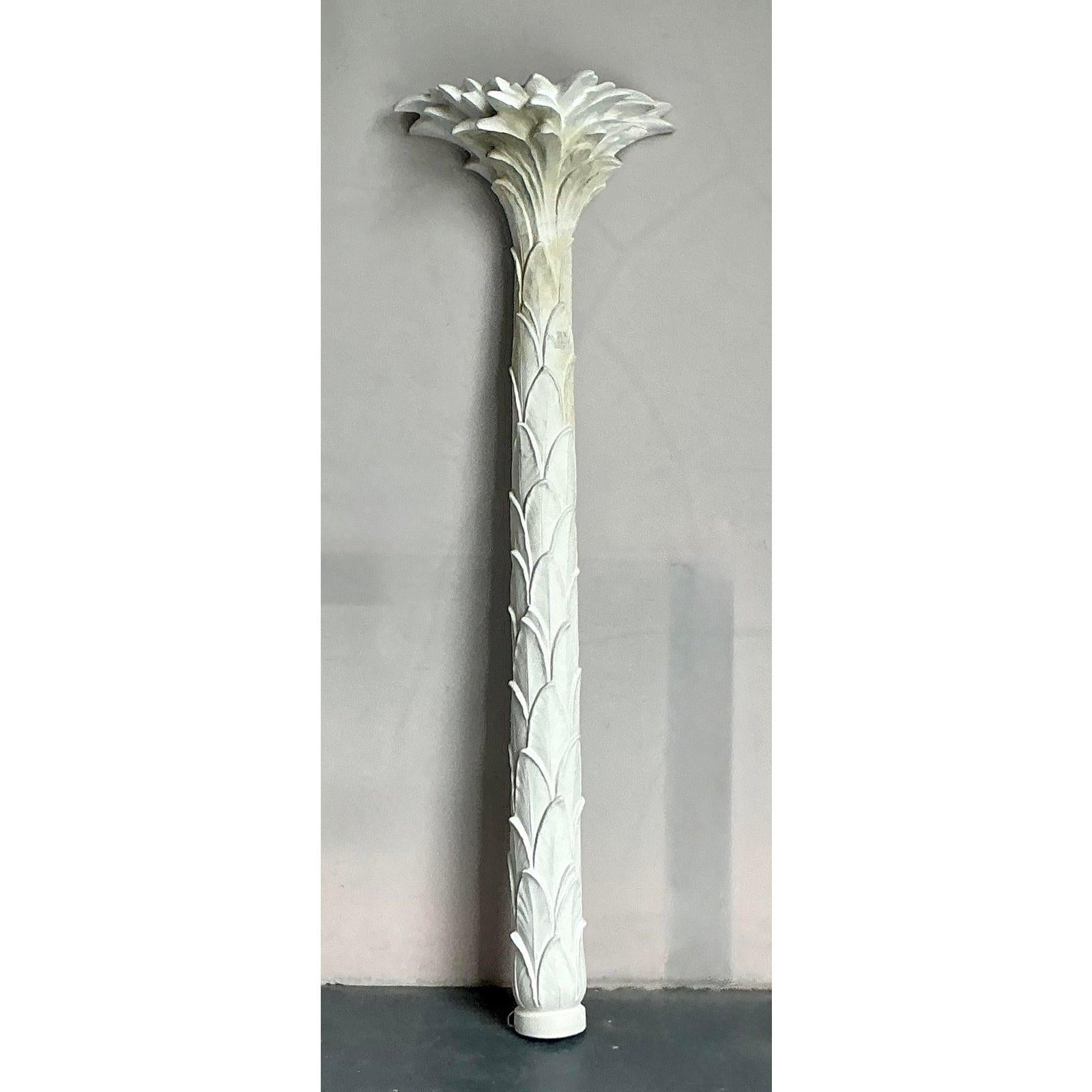 Elevate your interior with this magnificent vintage Hollywood Regency cast plaster palm torchiere, a sculptural lighting fixture that embodies the grandeur and dramatic flair of its era. This striking piece features a beautifully detailed palm frond