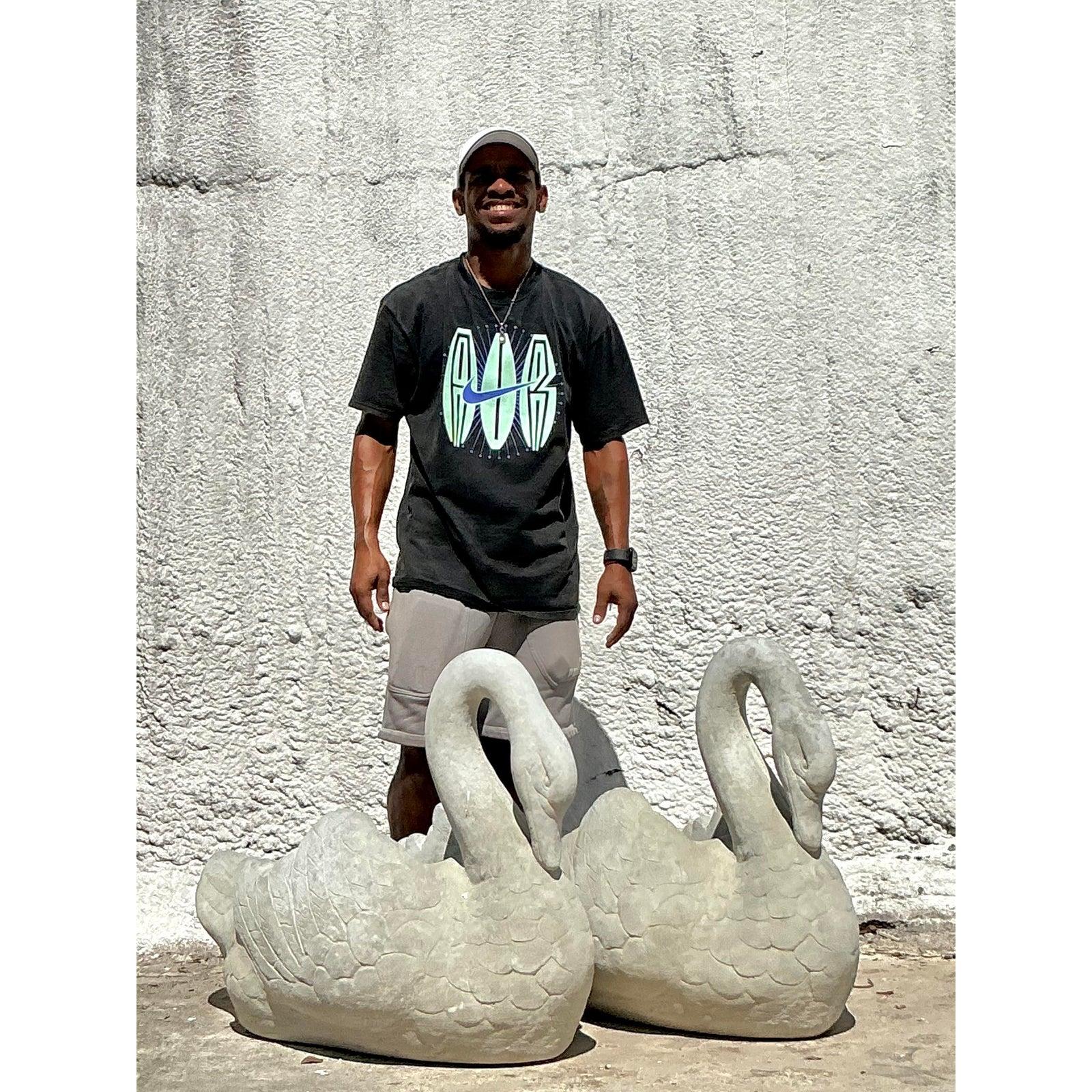 Bring a touch of stately, European garden elegance to your home or landscape with this majestic pair of vintage swan planters. Each swan is rendered in durable cast stone, featuring a gracefully curved neck and beautifully detailed feathers that