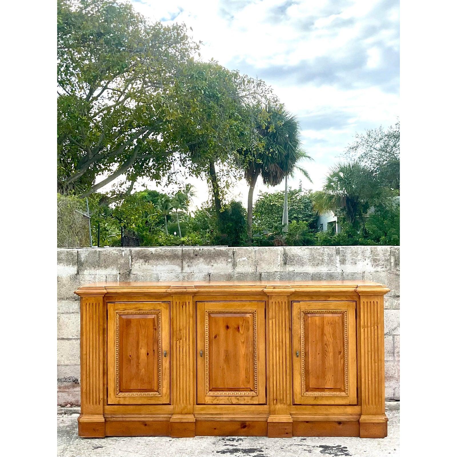 Exceptional vintage Regency pine credenza. Made by the iconic Century Furniture group. Beautiful column detail and stunning wood grain detail. A beautiful warm patina from age. Lots of great storage below. Acquired from a Palm Beach estate.