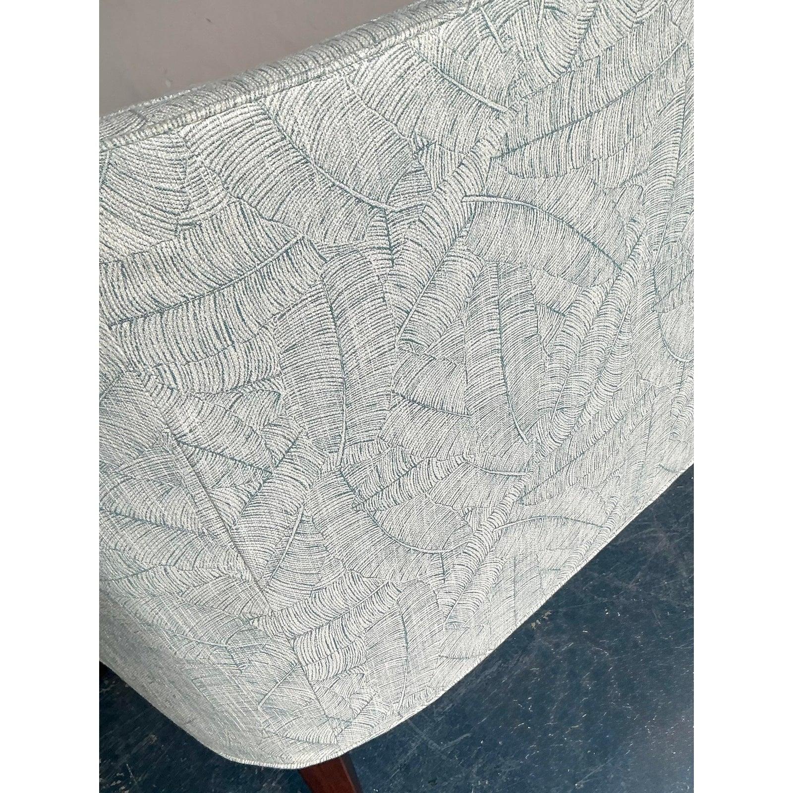 Elevate your dining or living space with the tailored sophistication of this vintage channel tufted settee. The piece features a dramatic high back defined by vertical channel stitching, creating a sleek, linear profile that draws the eye upward.