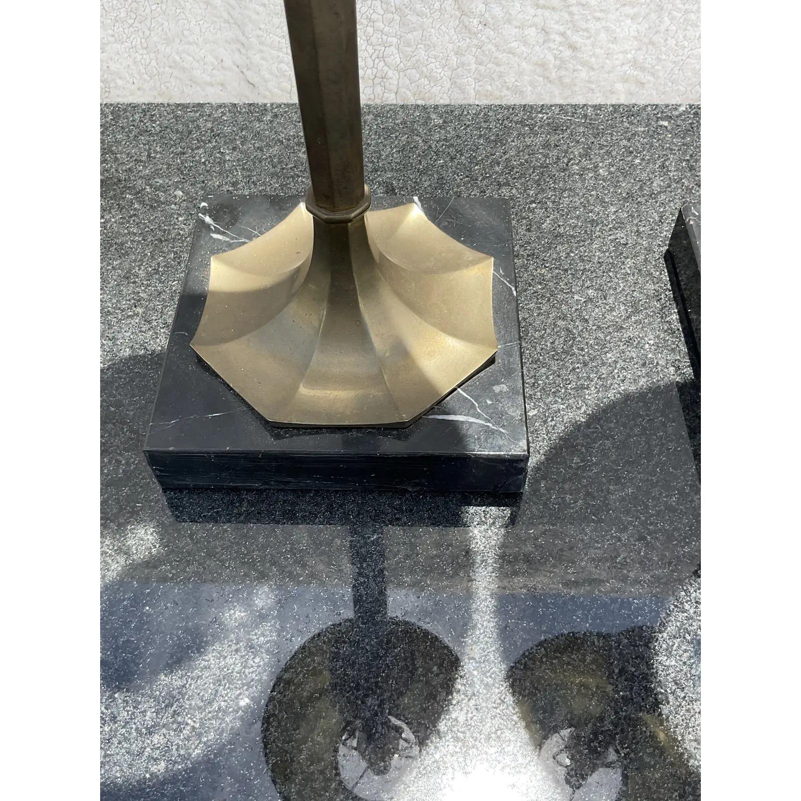Fantastic pair of vintage Regency table lamps. Made by the iconic Chapman group. Beautiful candlestick shapes resting on black marble plinths. Coordinating shape with matching finials. Acquired from a Palm Beach estate.