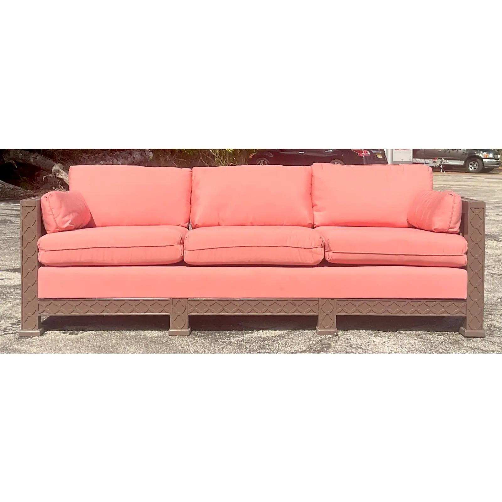 A fantastic vintage Regency wood frame sofa. A chic Chinese Chippendale frame with an upholstered bench seat. Fretwork trim detail along the edge. Matching loveseat also available. Acquired from a Palm Beach estate.

The sofa is in great