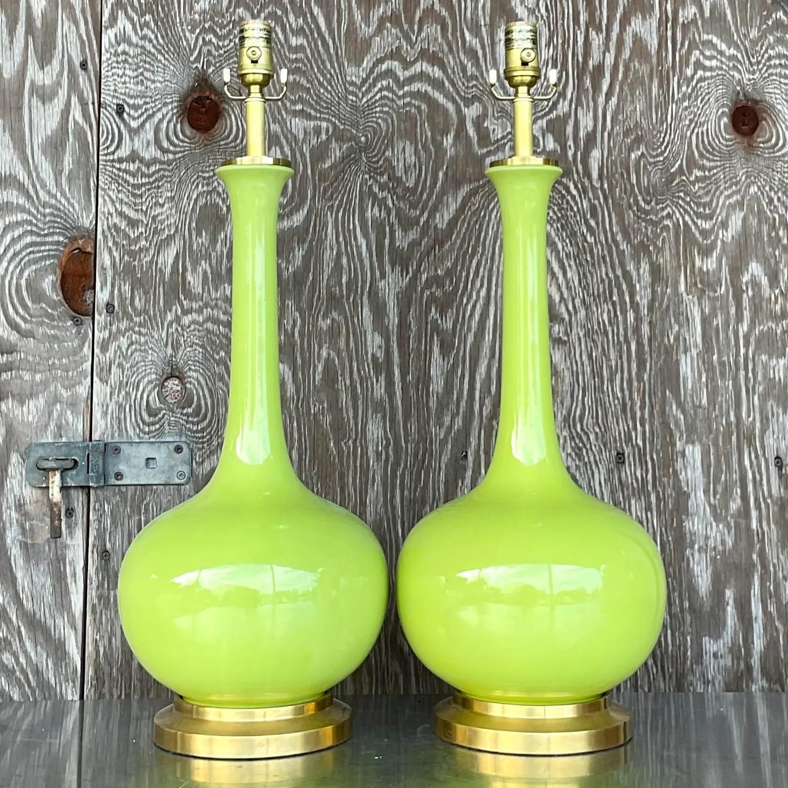 Fantastic pair of vintage Christopher Spitzmiller for Horchow large Coy table lamps. A gorgeous lime green in a glazed ceramic finish. Brushed brass hardware. Acquired from a Palm Beach estate