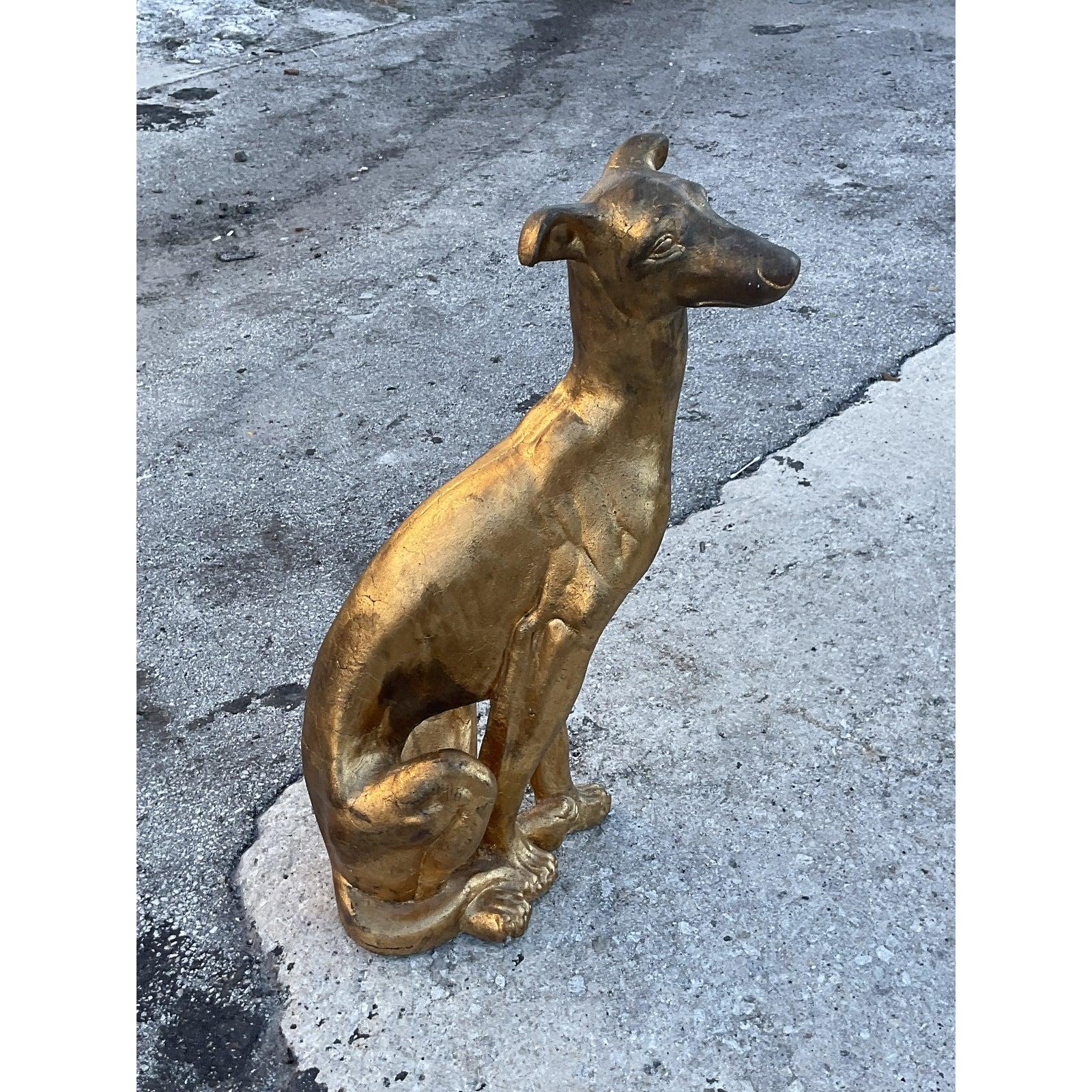 Fantastic vintage life size cement dog. A chic gold finish with a warm patina of time. A dramatic addition inside or outdoors. Acquired from a Palm Beach estate.