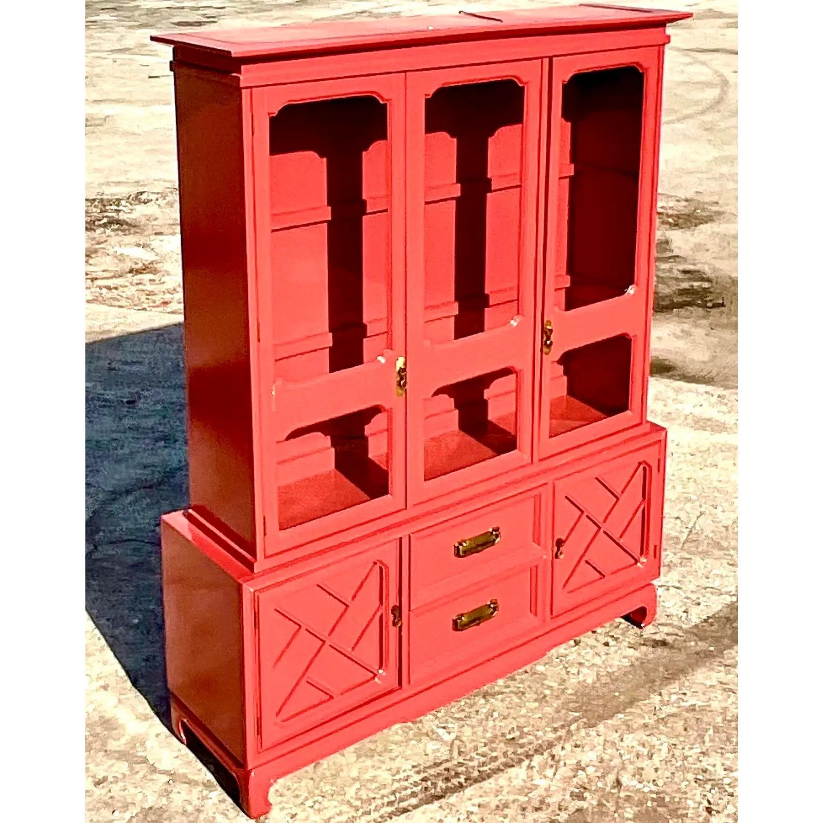 Fantastic vintage American of Martinsville display cabinet. Freshly lacquered in a high gloss Coral red. It just can’t help but draw attention. Fully restored with interior glass shelves and brushed brass hardware. Acquired from an iconic American