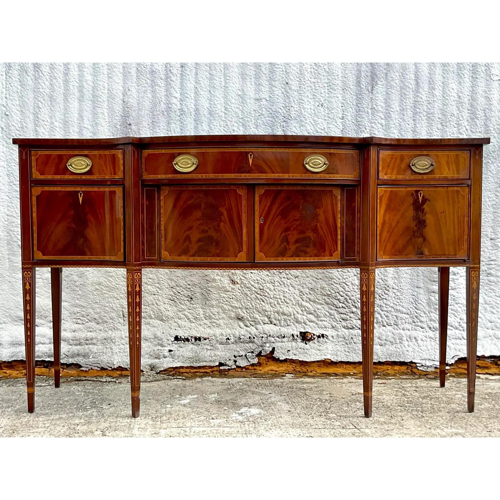 A fantastic vintage Regency tall sideboard. Made by the iconic Councill group. A beautiful flame mahogany with chic inlay detail. Acquired from a Palm Beach estate.