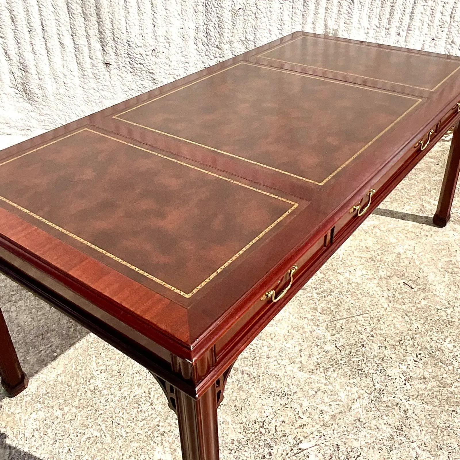 A fabulous vintage Regency Fretwork writing desk. Made by the iconic Councill Furniture group and marked on the drawer inside. Beautiful inset leather top with gold leaf detail. Acquired from a Palm Beach estate.
