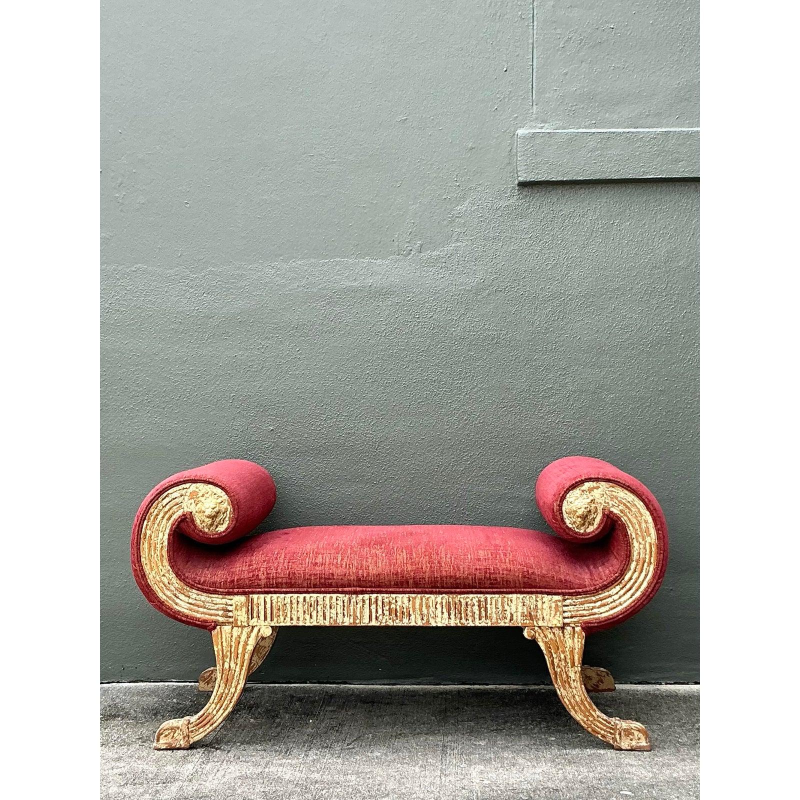 This elegant bench, or small chaise lounge, draws inspiration from Neoclassical and Grecian Klismos forms, updated with a touch of Hollywood Regency flair. It features distinctive, dramatically scrolled arms and curved legs with an intentionally