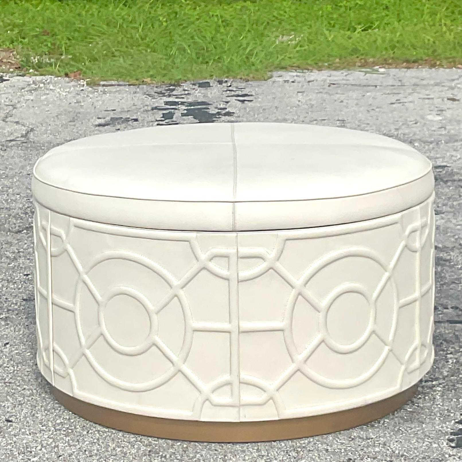 A fabulous vintage Regency storage ottoman. Beautiful tooled leather exterior with a chic grey suede interior. Gorgeous and functional. Acquired from a Palm Beach estate.