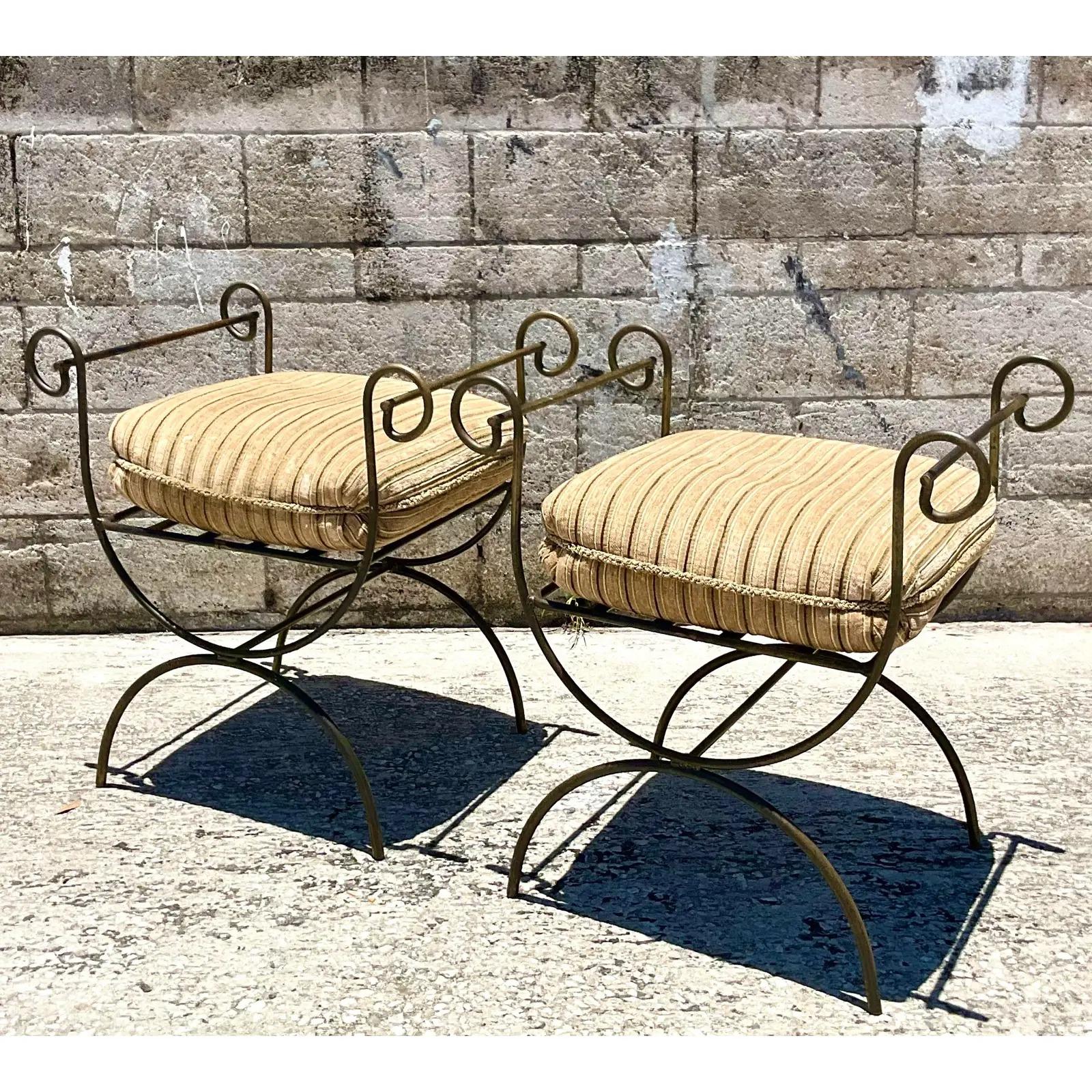 Fantastic vintage pair of wrought iron benches. Beautiful Savonarola Curule style with high rolled sides. Heavy down cushion. Acquired from a Palm Beach estate.