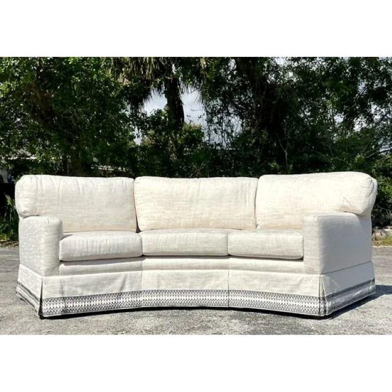 This Vintage Regency Custom Angled Sofa is a stunning statement piece that combines timeless elegance with bespoke craftsmanship. Designed with a unique angled silhouette, it effortlessly enhances the flow and visual appeal of any room. The sofa