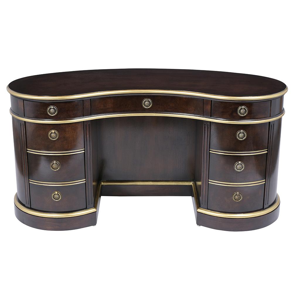 An Extraordinary Regency style Executive Desk finely crafted out of walnut wood featuring a kidney shape top an elegant ebonized color finish with intricate gilt molding details throughout the entire piece. This writing table comes with nine drawers