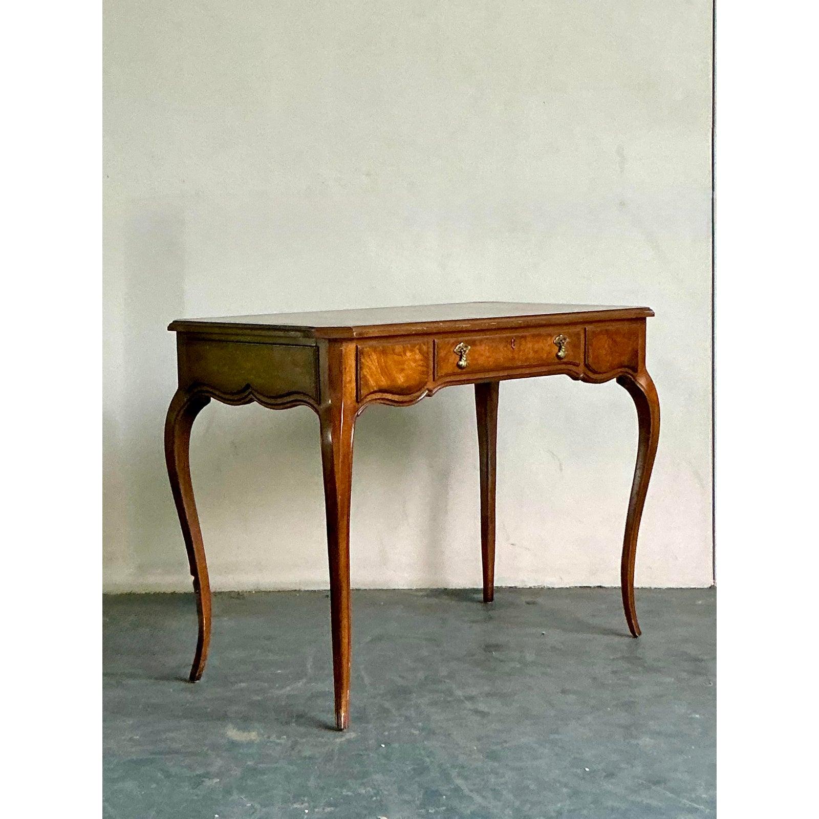 A masterpiece of classic design, this vintage writing desk by renowned maker Drexel embodies the grace and sophistication of the French Provincial style. The desk's exquisite silhouette is defined by its elegantly curved cabriole legs and a