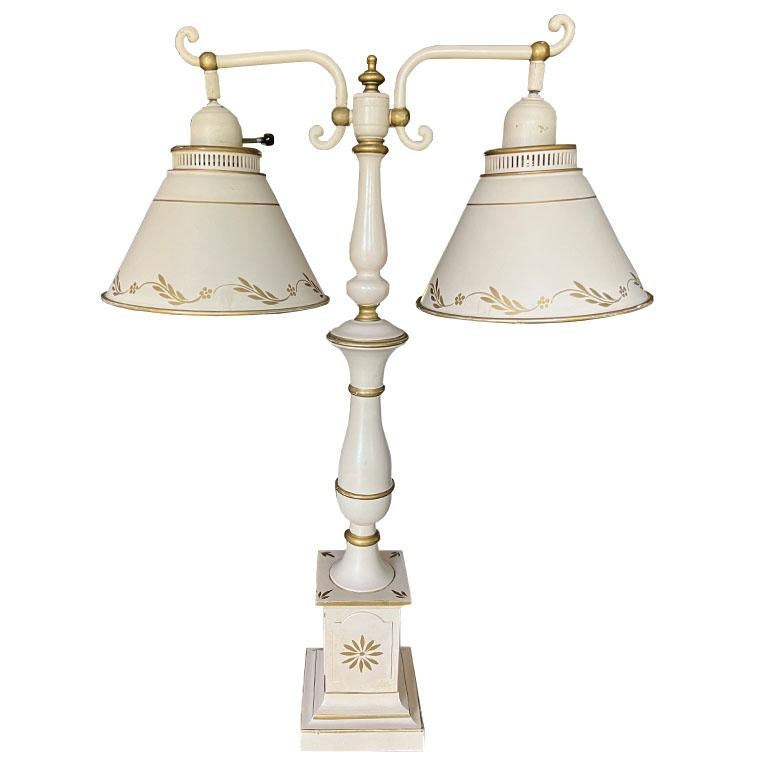 A pretty dual-arm tole table lamp. This piece will bring a soft glow to any space. Imagine it in a little girl's room in the middle of two twin beds! The entire lamp is created from metal and painted in a soft baby pastel pink. The round shades on