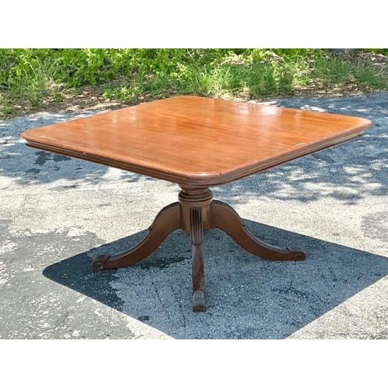 Elevate your interior with this distinguished Vintage Regency Duncan Phyfe Square Table, a timeless piece that blends historical elegance with versatile functionality. Crafted from rich, lustrous wood, likely a fine mahogany, this table features a