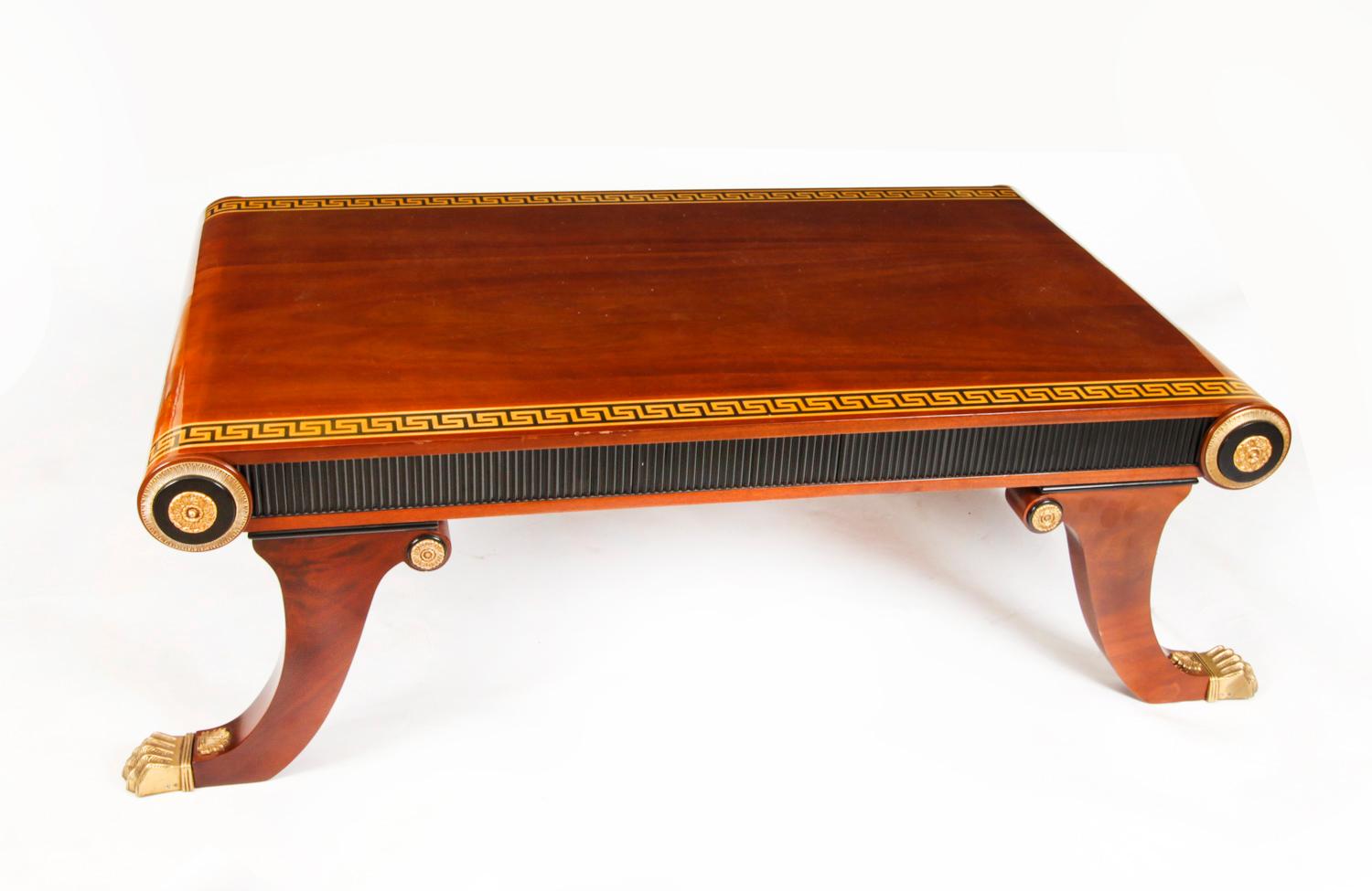 This is a stunning Vintage large walnut coffee table, with Greek key border, scroll ends, ormolu mounts and sabre legs that terminate in ormolu lion's paw feet, dating from the last quarter of the 20th century.

In the in the Regency Egyptian