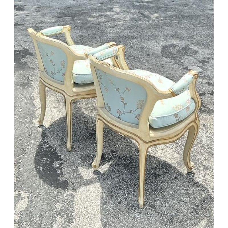 Experience the allure of classic European design with this exquisite Pair of Vintage French Regency Fauteuil Armchairs. Each chair is a testament to sophisticated craftsmanship, featuring elegantly curved giltwood frames meticulously hand-carved