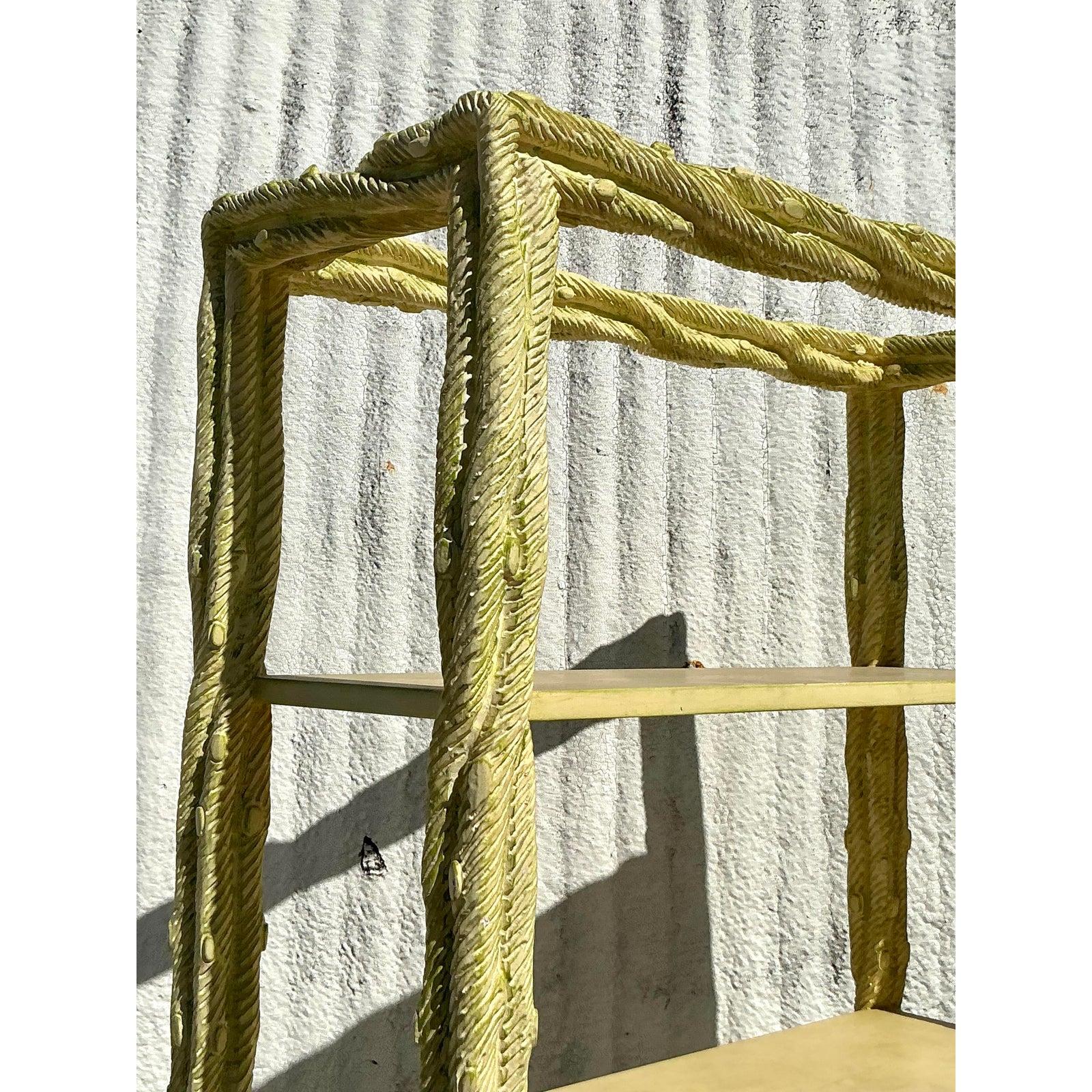 Aggiungi un tocco di eleganza al tuo spazio con questa splendida étagère vintage in faux bois, caratterizzata da una squisita cornice intagliata a forma di corda che emana un raffinato fascino Regency. La scaffalatura aperta a cinque livelli offre