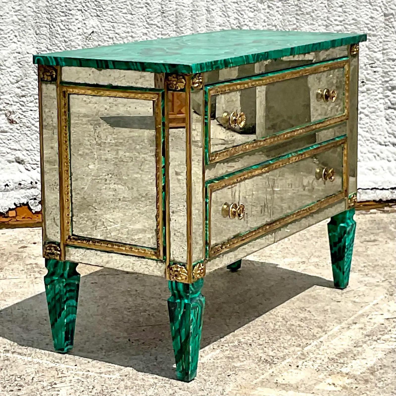 An extraordinary vintage Regency chest of drawers. A truly magnificent piece of furniture with a hand done Malachite finish with inset vintage mirrored panels and gilt trim. This is the kind of piece that you design a whole room around. Acquired
