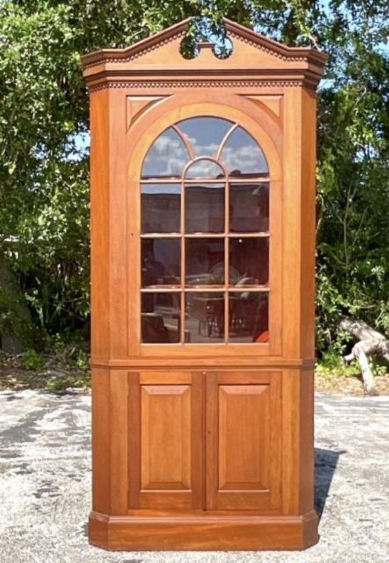 Un asombroso armario esquinero de cerezo estilo Regency Federal de época americana, diseñado por expertos para realzar cualquier habitación con su rica madera de cerezo y sus elegantes detalles de época Federal. Esta pieza combina la estética