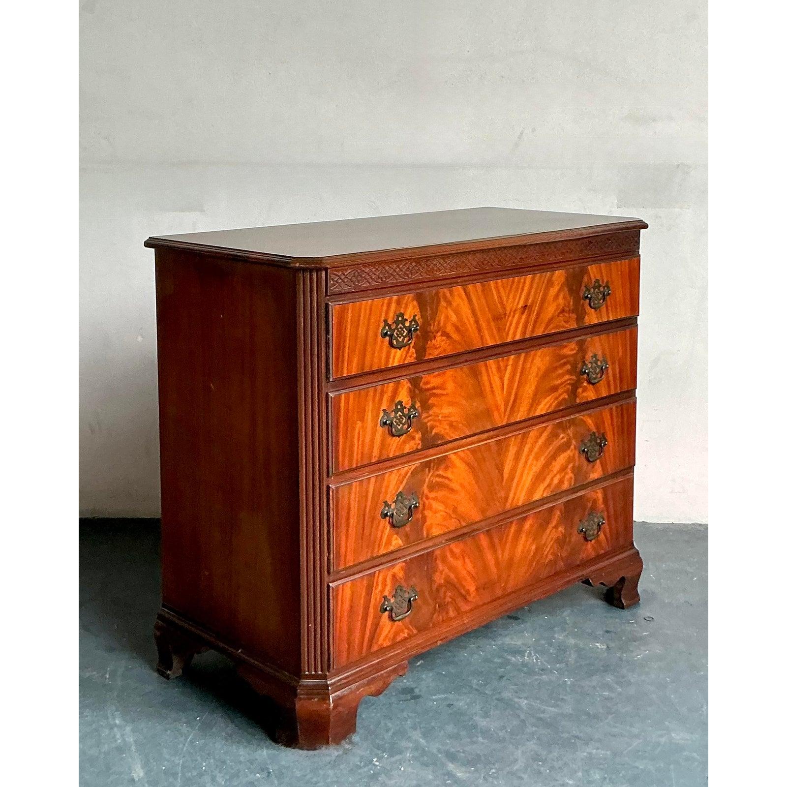 Presenting a superb Vintage Regency Flame Mahogany Chest of Drawers, a distinguished piece that effortlessly blends classic elegance with practical functionality. This exquisite chest, dating from the early 20th century, showcases the timeless