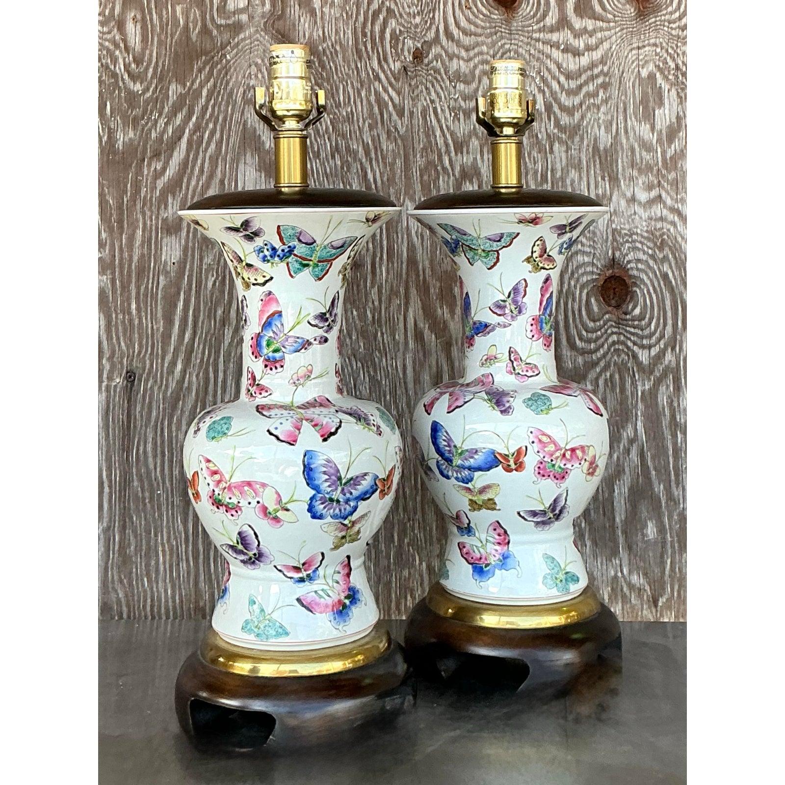 Elevate your space with this exquisite pair of vintage Frederick Cooper Mariposa lamps, featuring a stunning hand-painted butterfly motif on a pristine ceramic body. The delicate and colorful butterflies flutter across a soft ivory background,