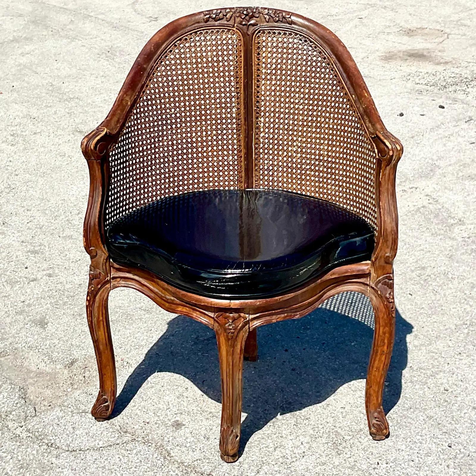 Vintage Regency French cane chairs. A beautiful triangle Bergere shape. Inset cane panels and hard carved details. Acquired from a Palm Beach estate.

The chair is in great vintage condition. Minor scuffs and blemishes appropriate to its age and