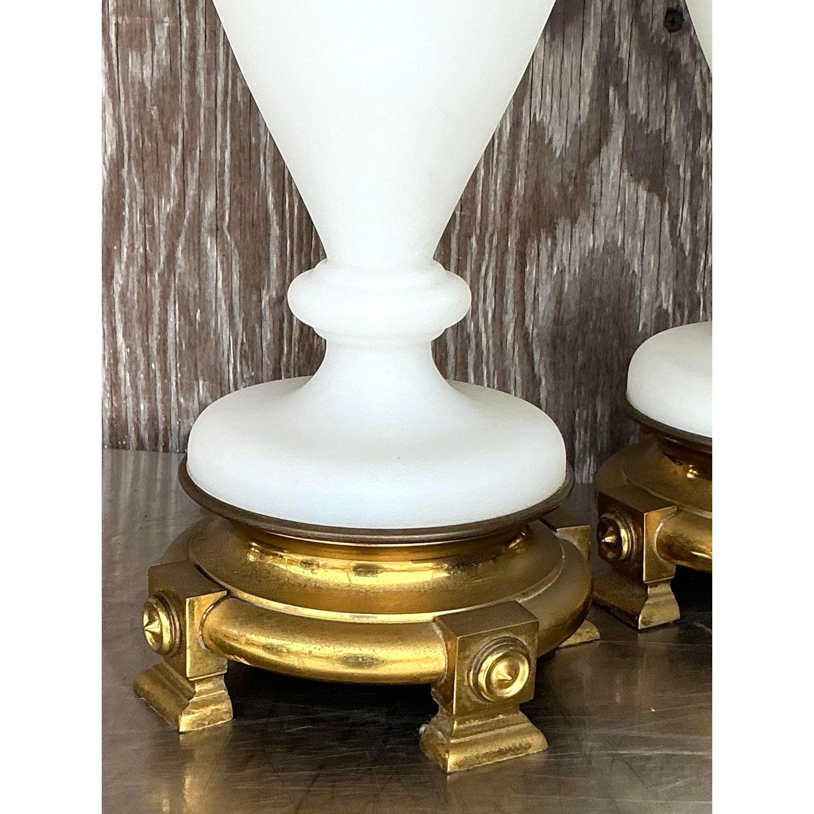 Elevate your interior with this exquisite pair of Vintage Regency French Opaline Lamps, featuring timeless neoclassical urn silhouettes crafted from milky white opaline glass. Resting on ornate gilt brass bases with sculptural legs and topped with