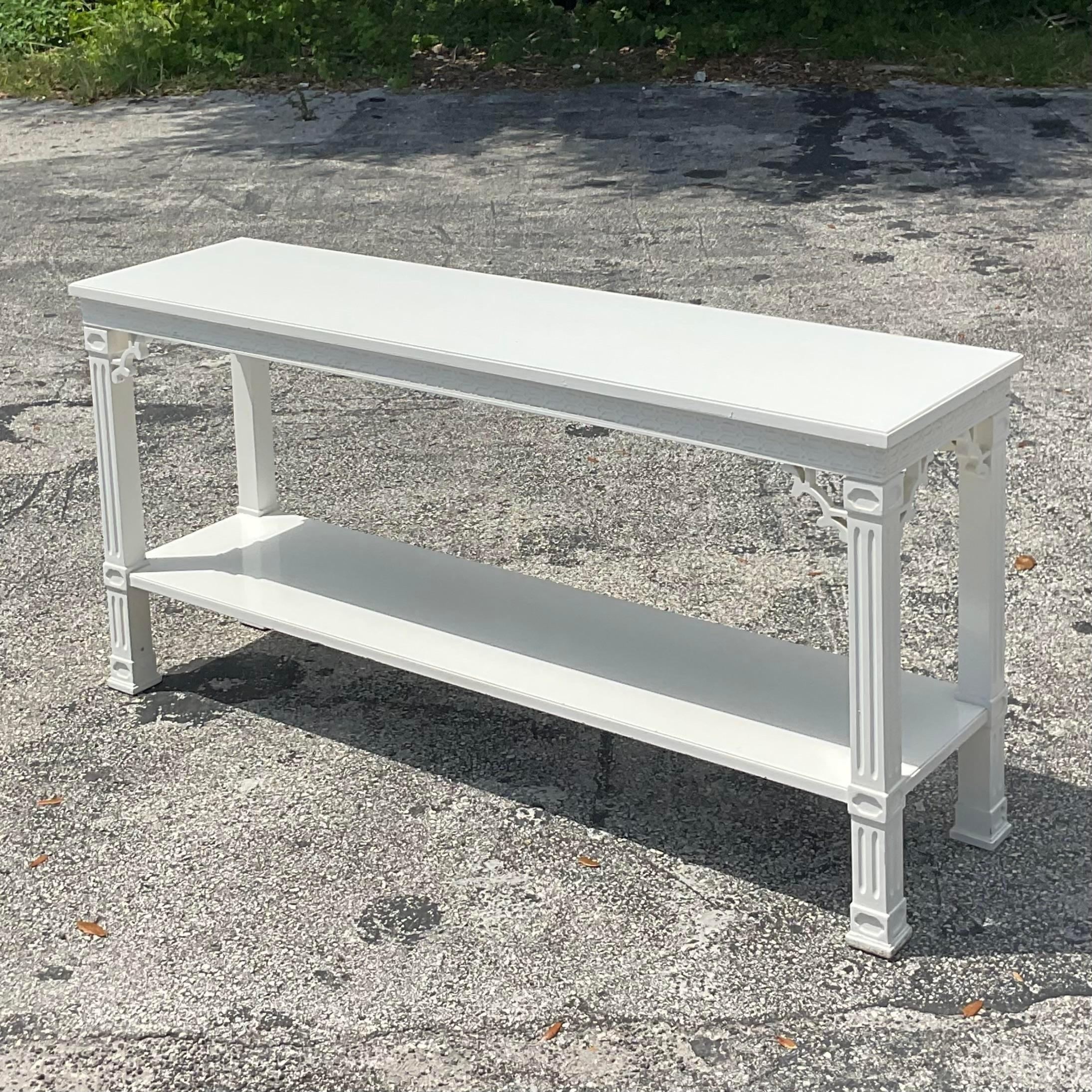 A fabulous vintage Regency console table. Tall and not too deep so it’s perfect for those narrow spaces. Chic semigloss white finish with gorgeous fretwork detail. Two tables available on my page if a pair is needed! Acquired from a Palm Beach