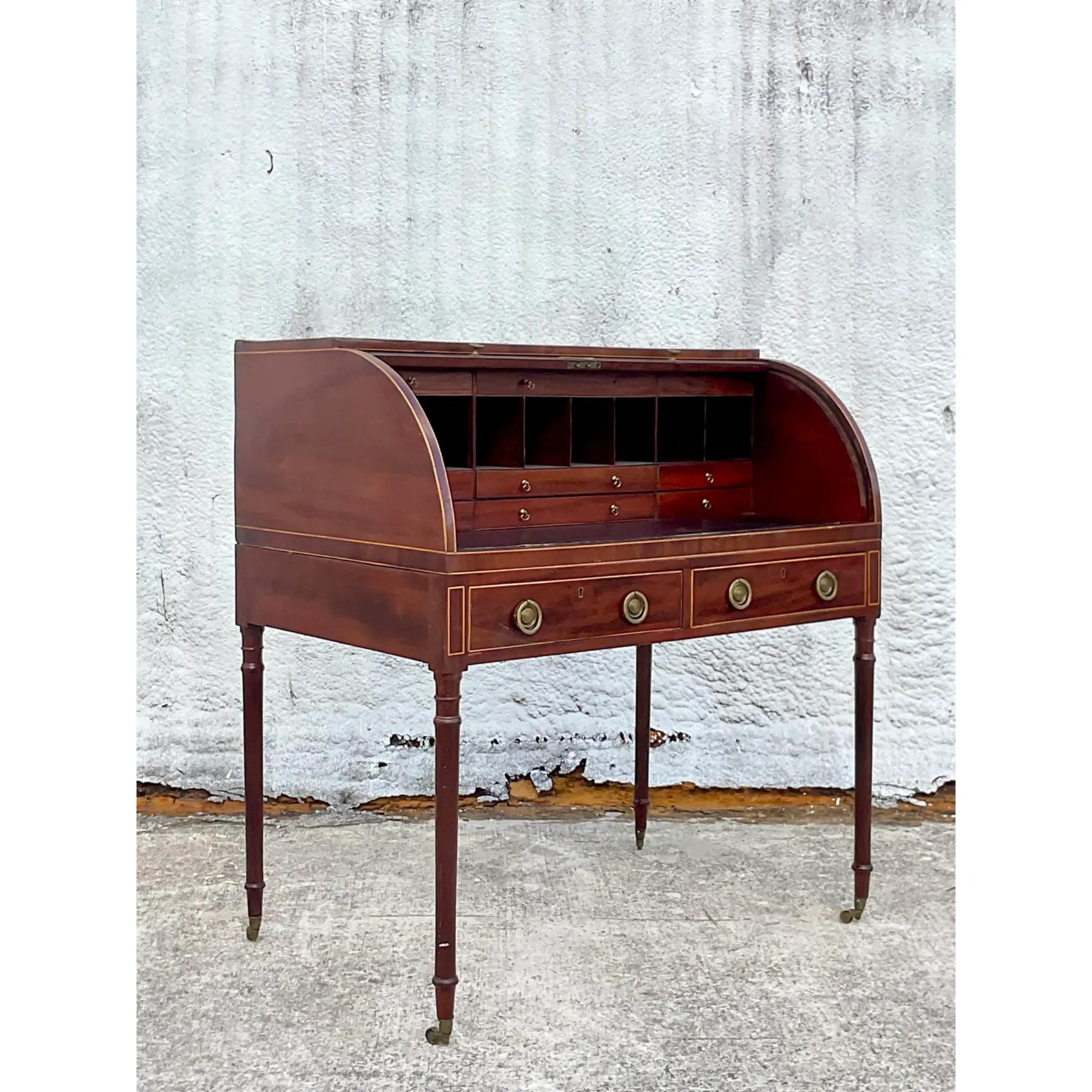 A stunning vintage Regency writing desk. A chic George III style with a chic roll top. Inlay leather writing area. Lots of little drawers and slots for organizing. A real showstopper. Acquired from a Palm Beach estate.