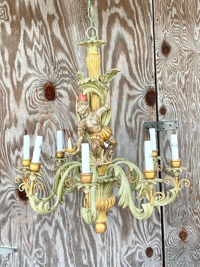 A fabulous vintage Boho chandelier. A charming monkey in a little hat climbing thru the vines. Gesso over gilt wood with a matte finish. Acquired from a Palm Beach estate.