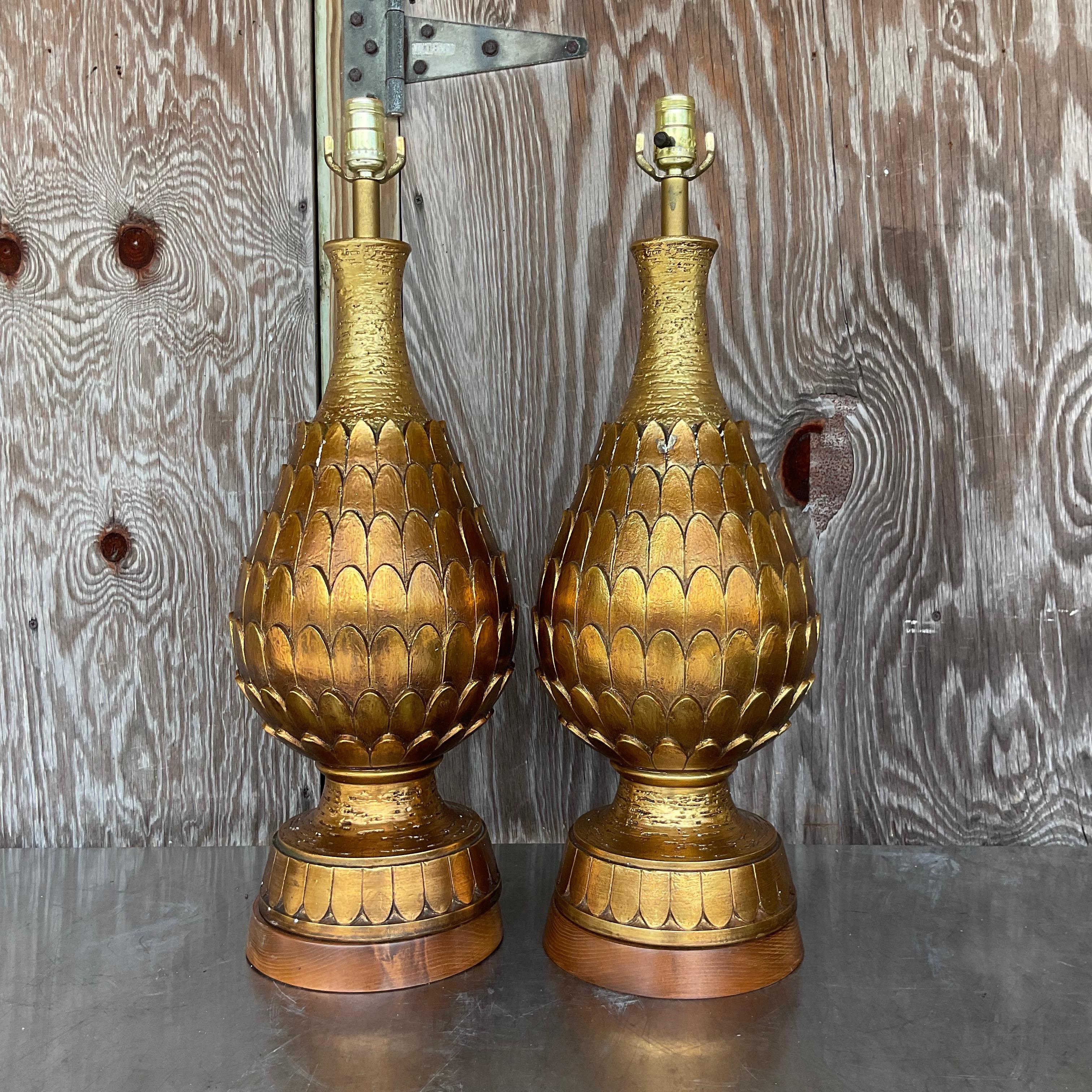 A fabulous pair of vintage MCM table lamps. A chic gilt finish on a period artichoke design. Tall and impressive. Acquired from a NY estate.