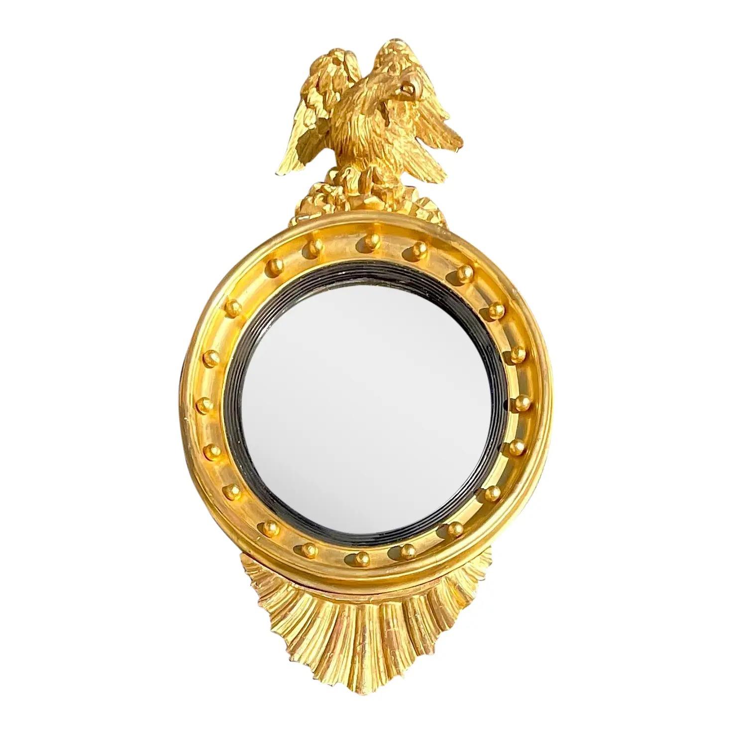An incredible vintage Federal convex mirror. A beautiful gilt over gesso wood frame with iconic eagle detail. Additional shell detail on the bottom. Acquired from a Palm Beach estate.

The mirror is in good vintage condition. Scuffs and blemishes