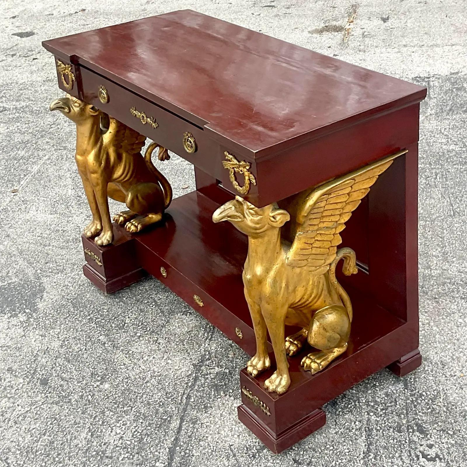 A stunning vintage Regency console table. Chic gilt griffins in a classic mahogany shape. A commanding presence. Acquired from a Palm Beach estate.