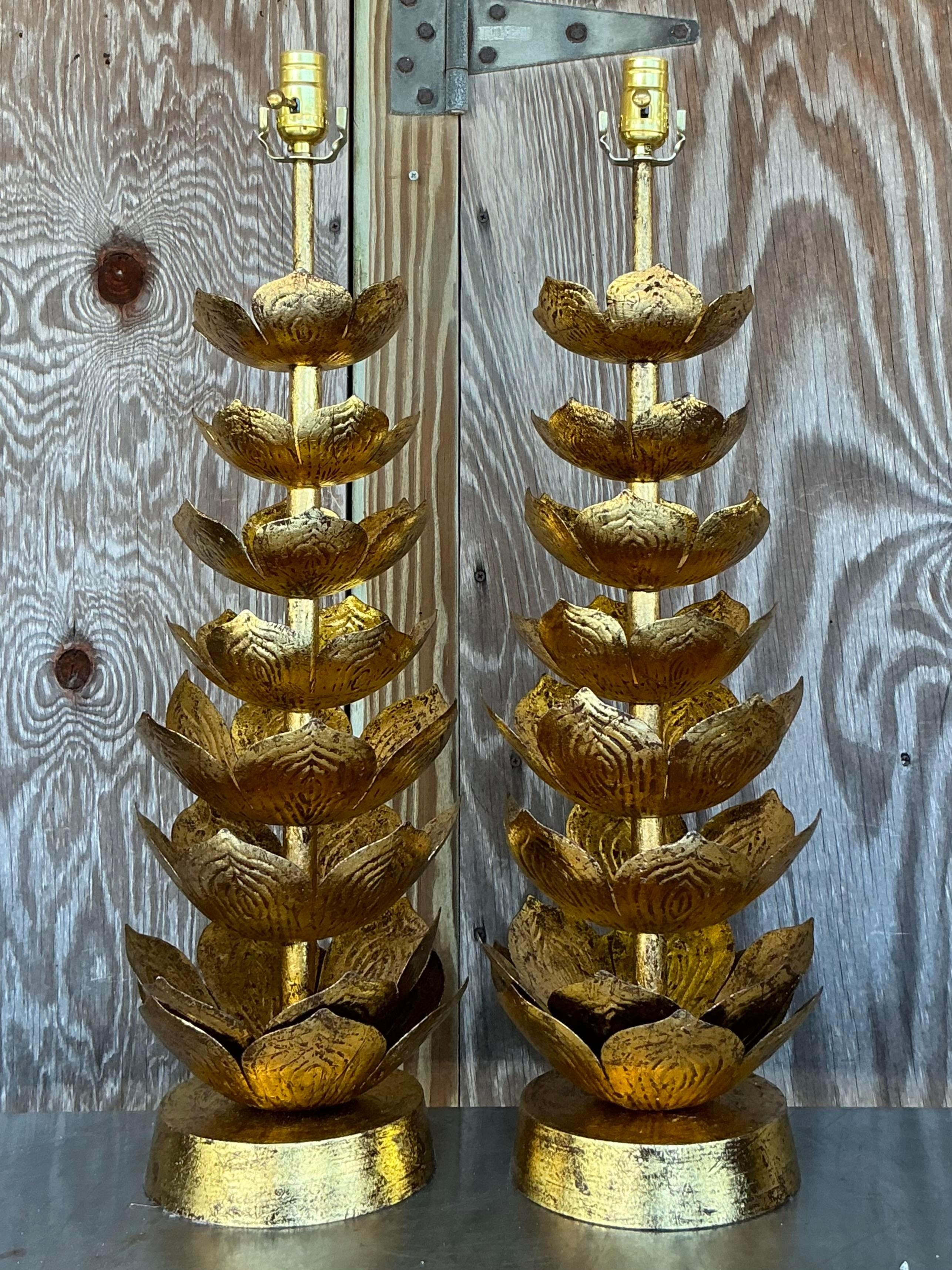 These vintage Regency gilt lotus blossom lamps, inspired by Feldman, epitomize American elegance. Featuring intricate gilt detailing and a timeless lotus blossom motif, these lamps illuminate with both style and sophistication, perfect for adding a