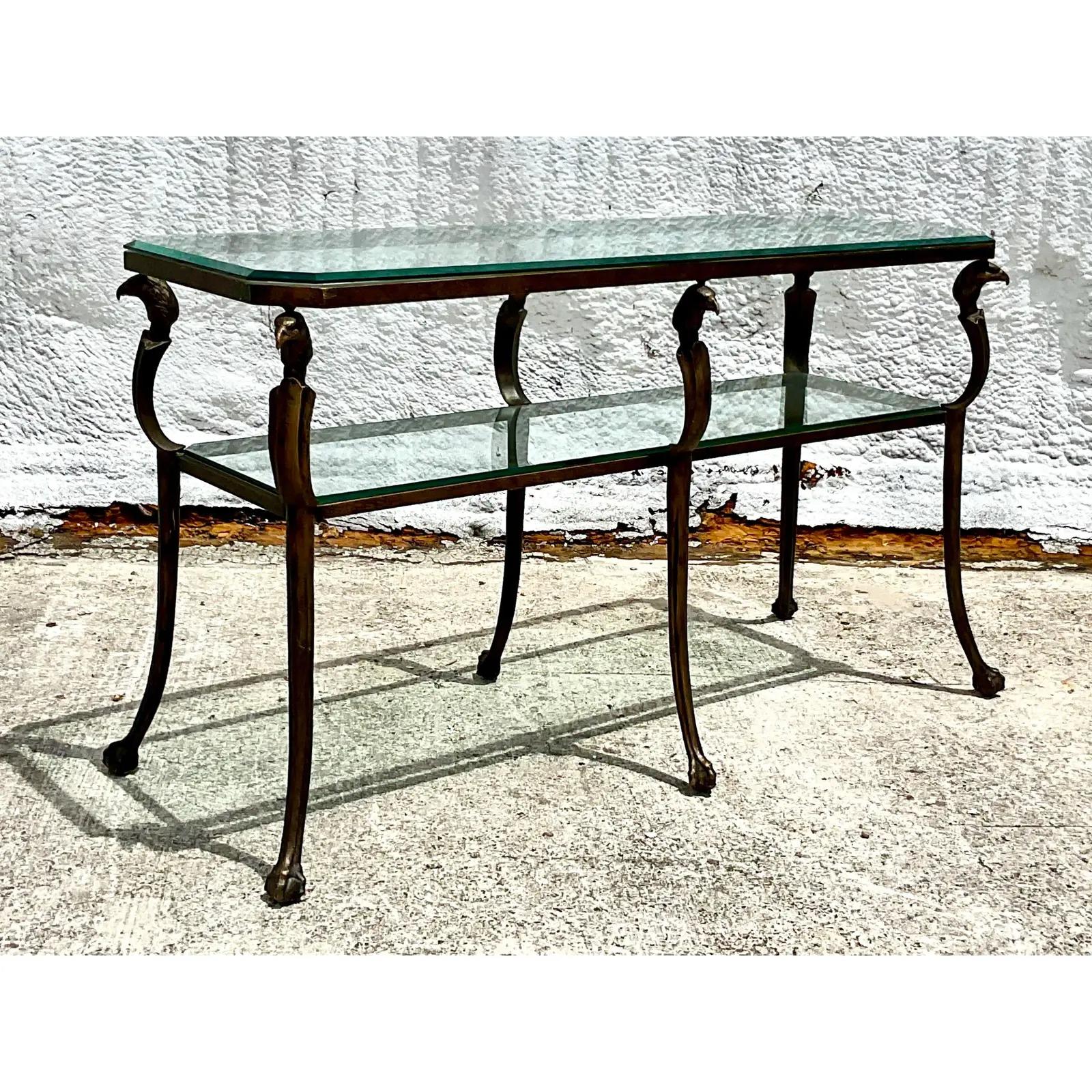 Vintage Regency gilt over metal console table. A chic bi-level rectangle shape with striking bird head design at each corner. Inset glass panels. Acquired from a Palm Beach estate.