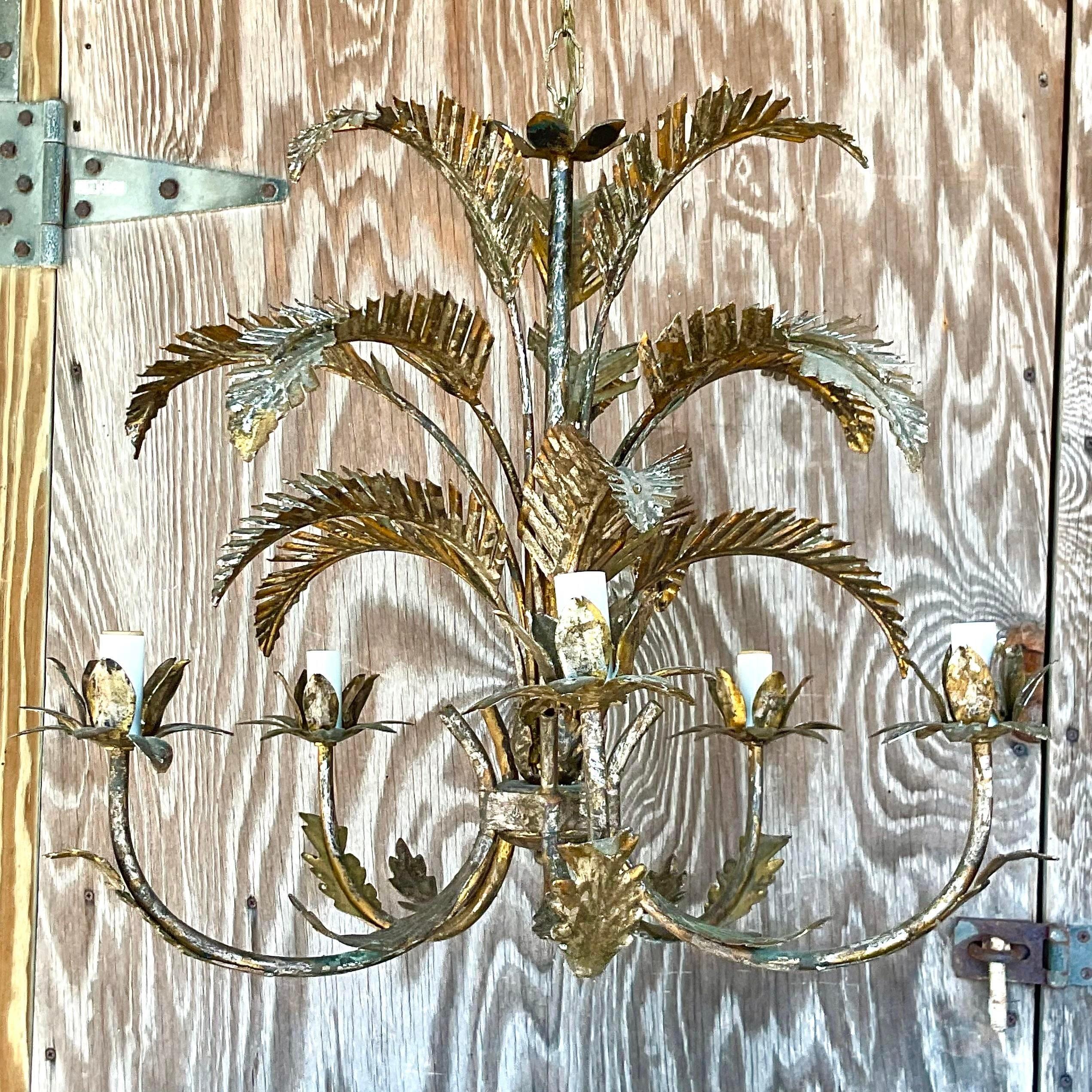 A fantastic vintage Regency chandelier. Beautiful gilt details on a chic palm frond design. Acquired from a Palm Beach estate.