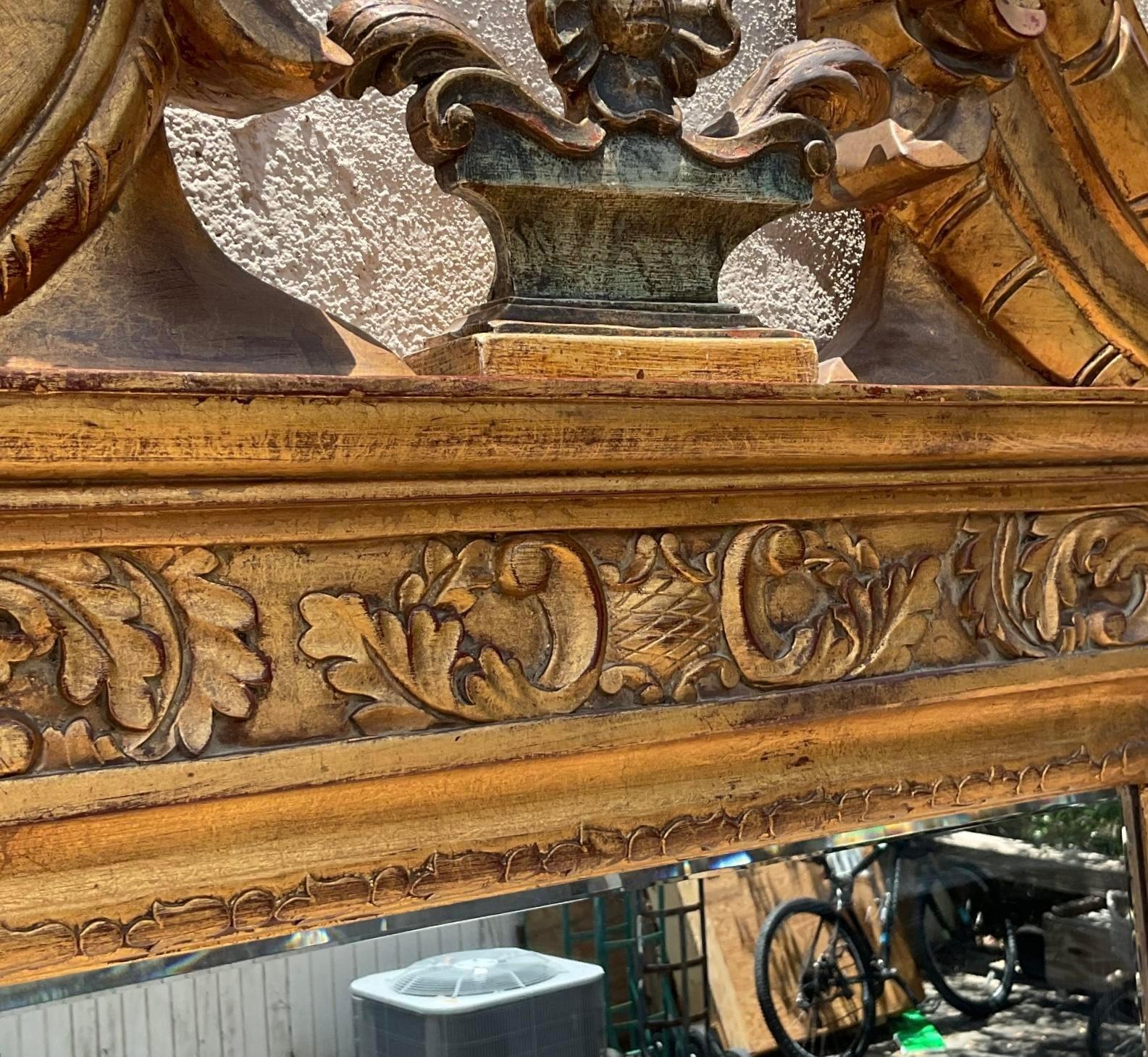 Elevate your décor with the regal allure of this Vintage Regency Gilt Pediment Mirror. Inspired by classic American design, its lavish gilt frame and intricate detailing exude opulence, adding a touch of grandeur to any room. Make a statement with