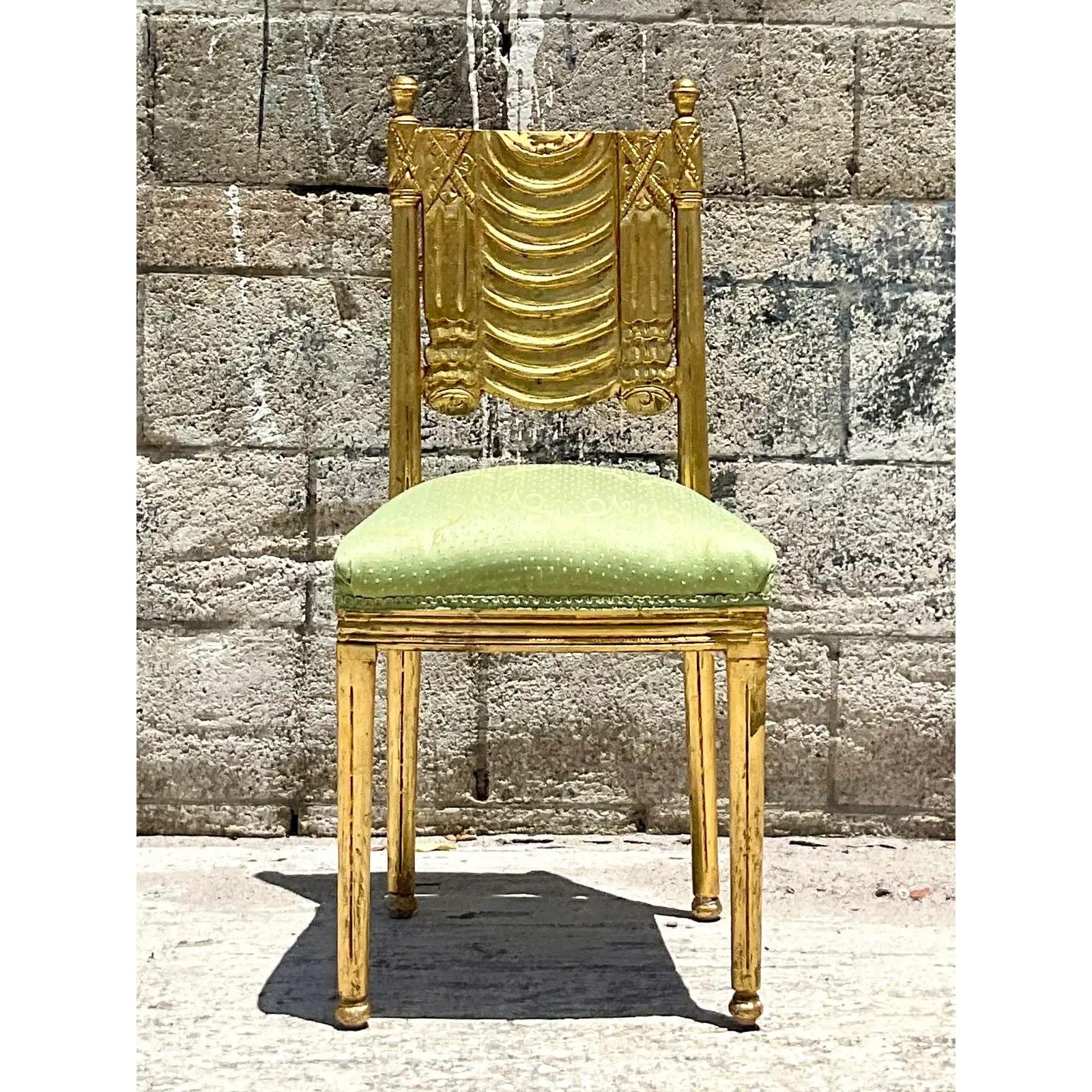 Vintage Regency side chair. Beautiful hand carved swag design in a glamorous gilt finish. Satin jacquard upholstery on the seat. Acquired from a Palm Beach estate.