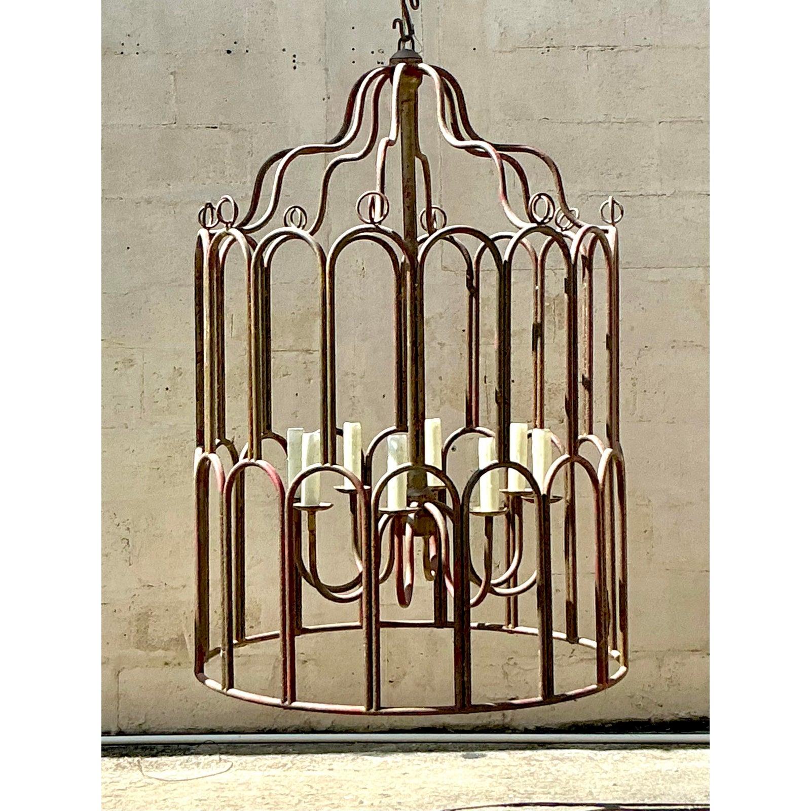 Command attention and infuse your space with palatial grandeur with this magnificent Vintage Regency Monumental Gilt Tipped Chandelier. This exceptional piece is an ode to classic European design, featuring an imposing birdcage-style frame crafted
